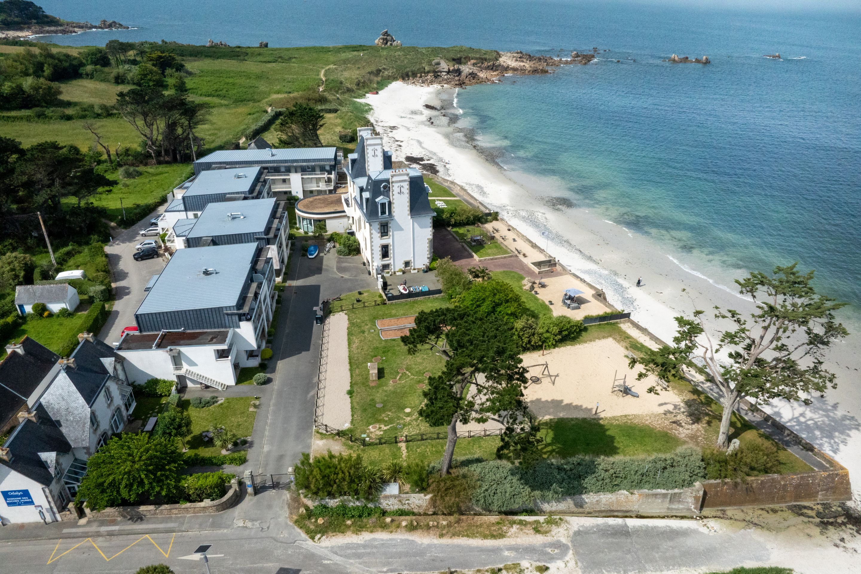 image This beachfront residence looks straight out over the sea, just past the grassy grounds.