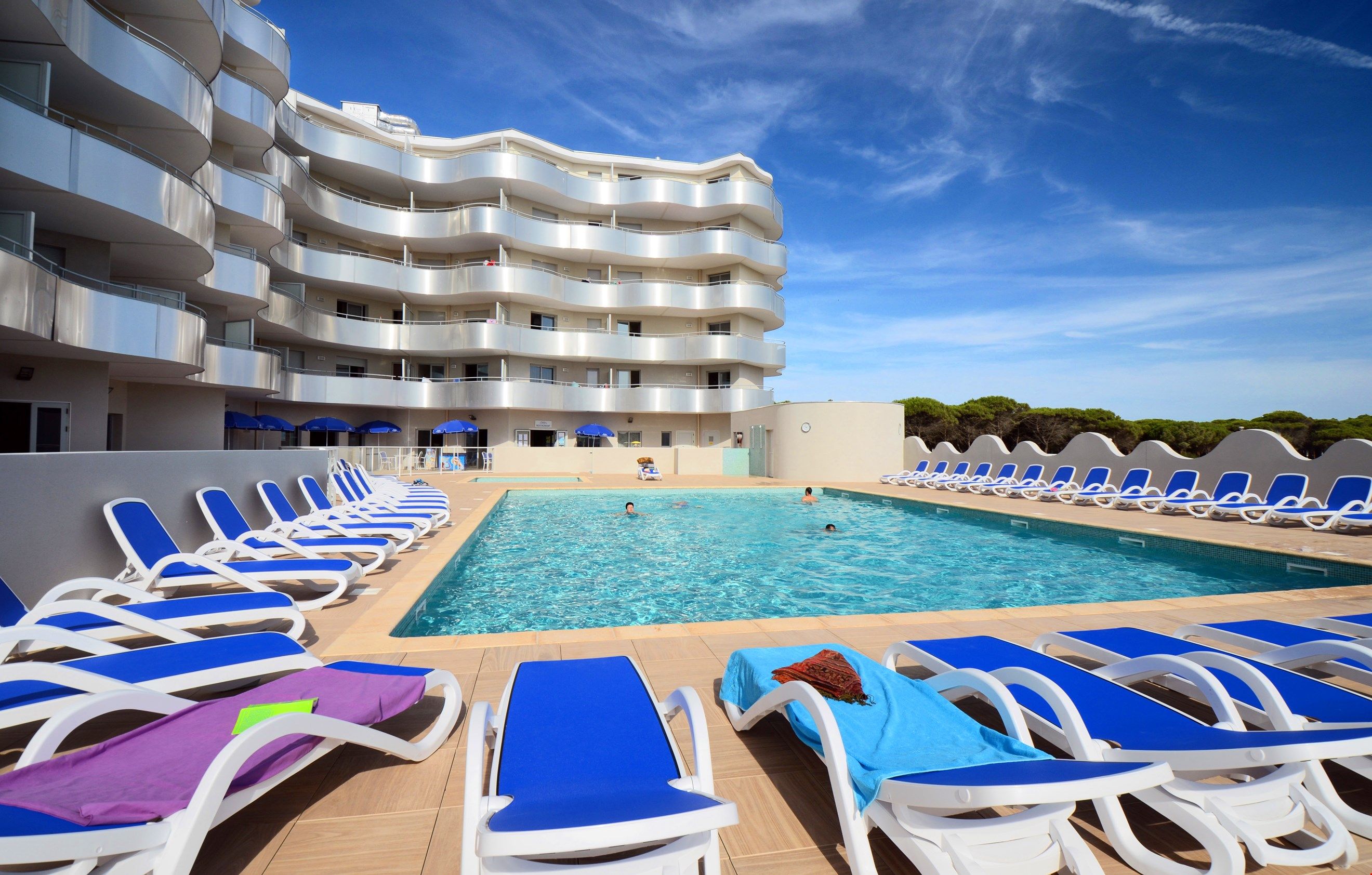 image Dive into the gorgeous outdoor pool on a hot summer day.