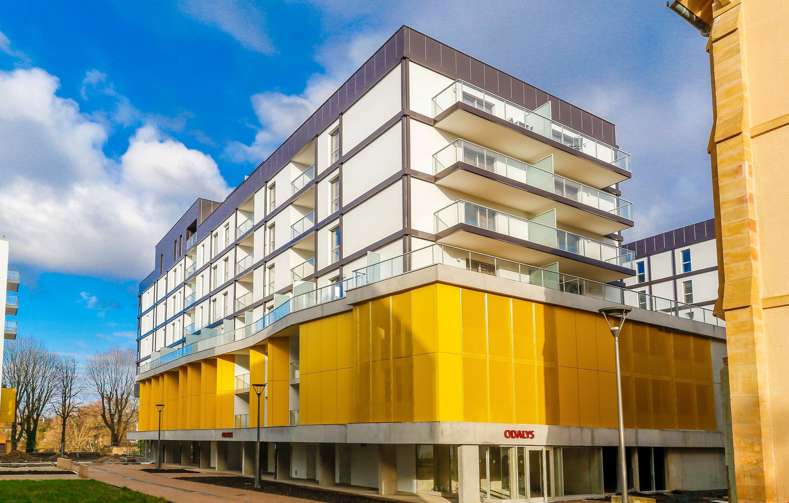 image Stylish high-floor residence with bold yellow panels, offering a bright and modern base for exploring Metz.