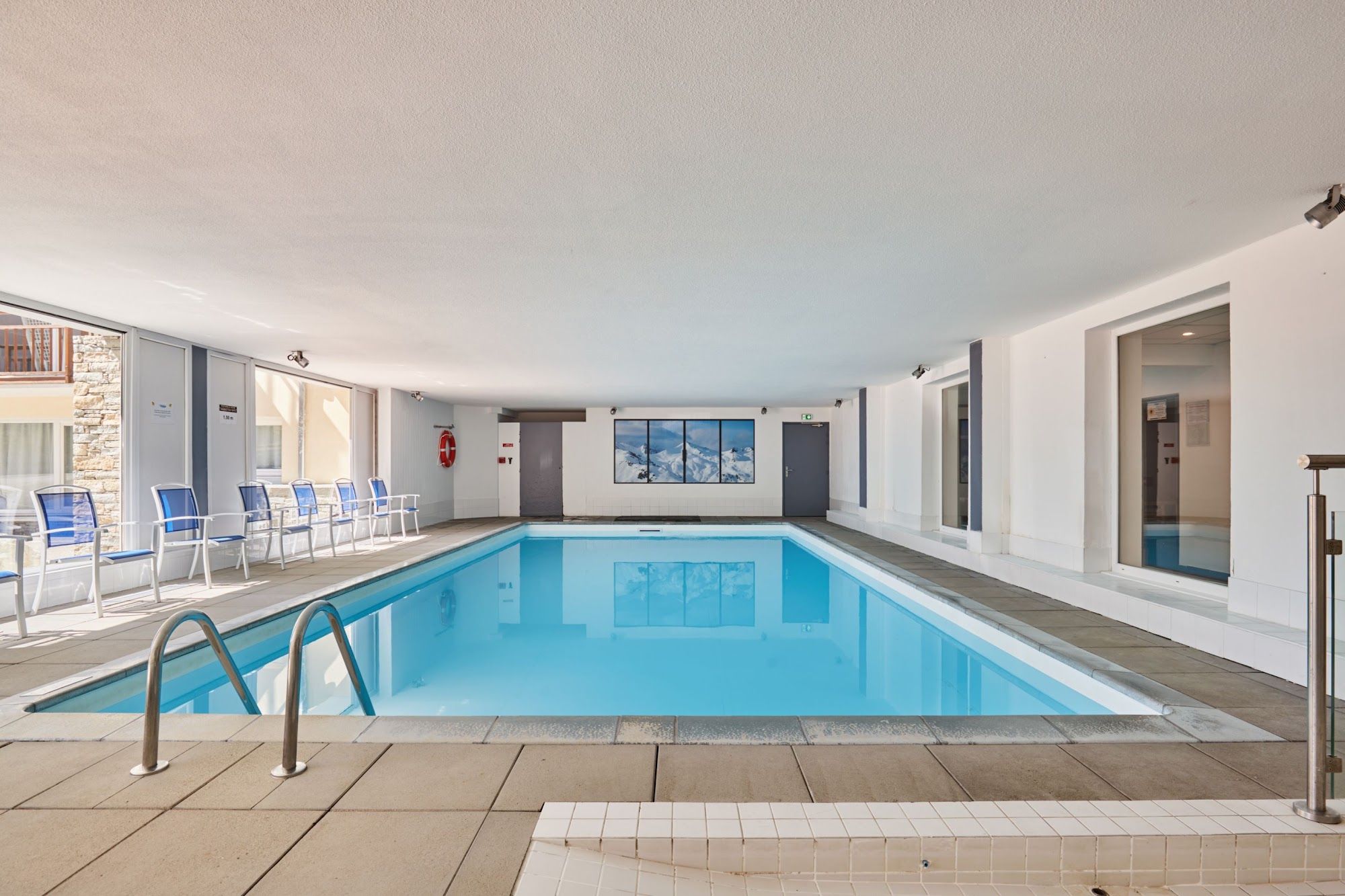 image Indoor swimming pool with lounge chairs along the water