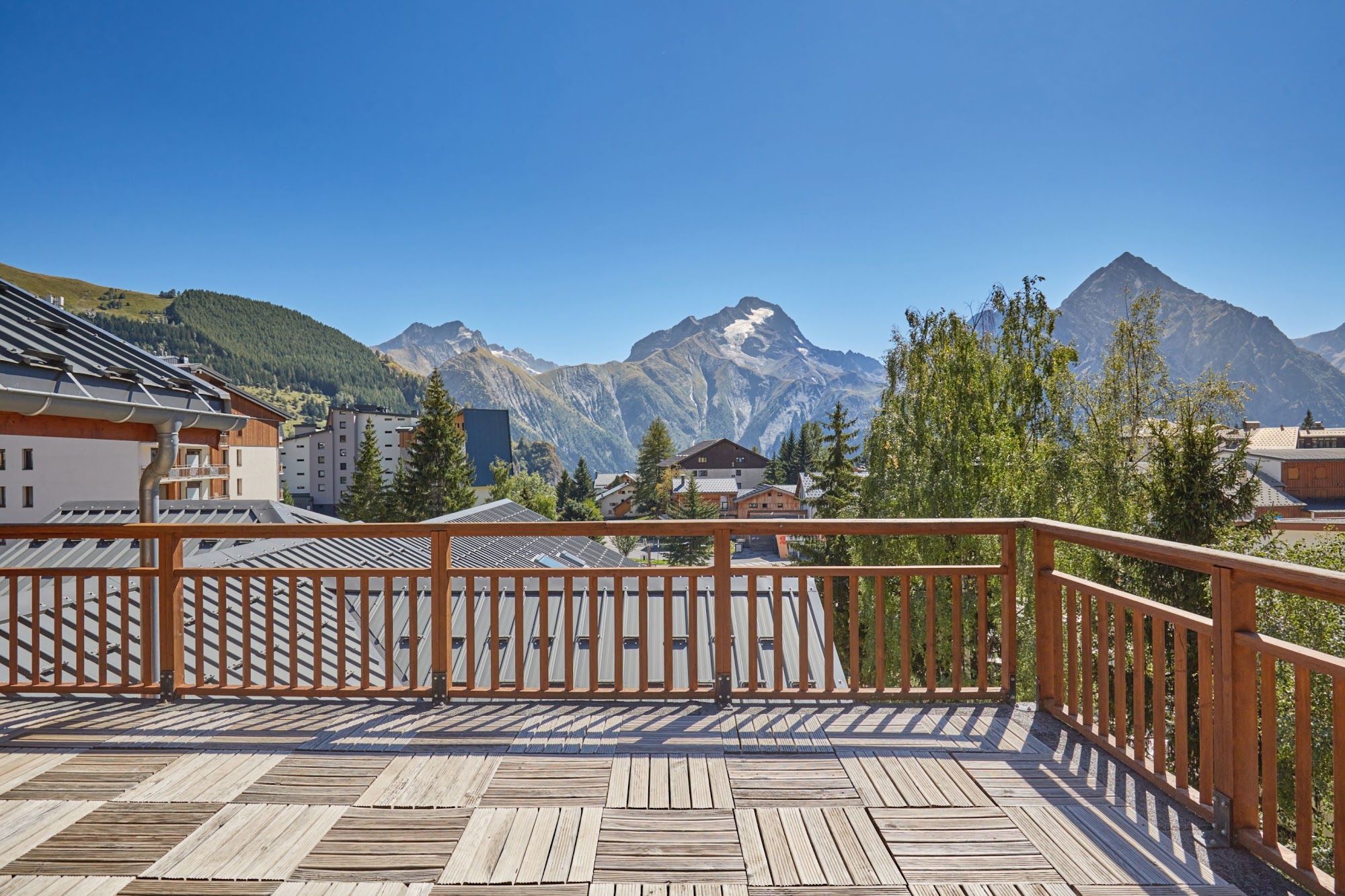 image Mountain view from a wooden terrace under a clear blue sky