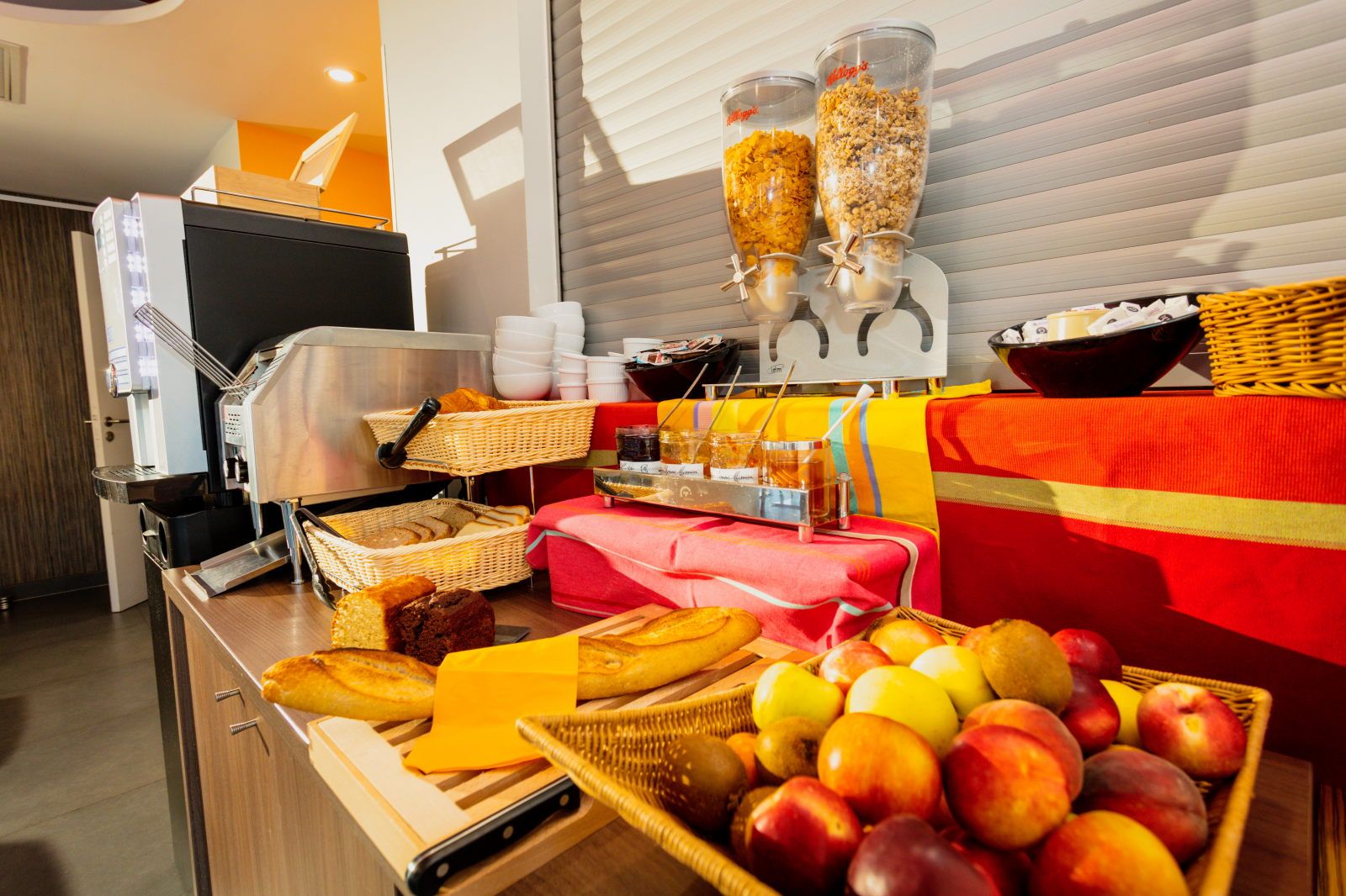 image Breakfast items including fruits and pastries arranged on a buffet table