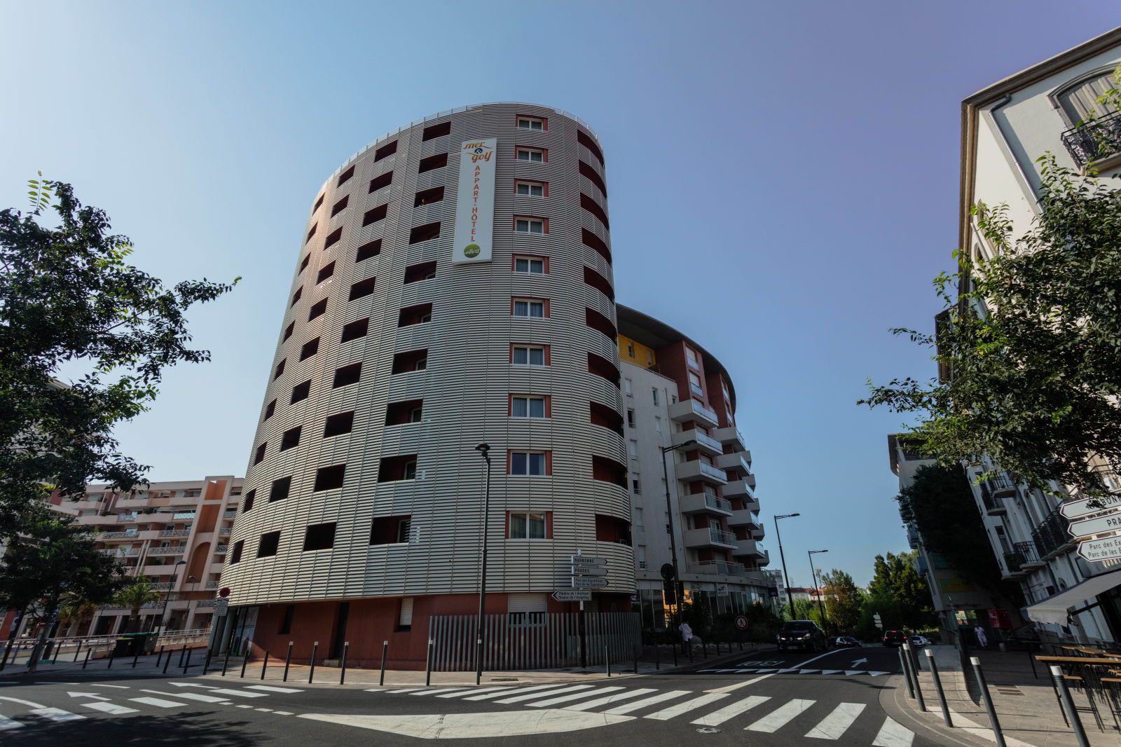 image Tall cylindrical building showcases a modern architectural design against a clear sky