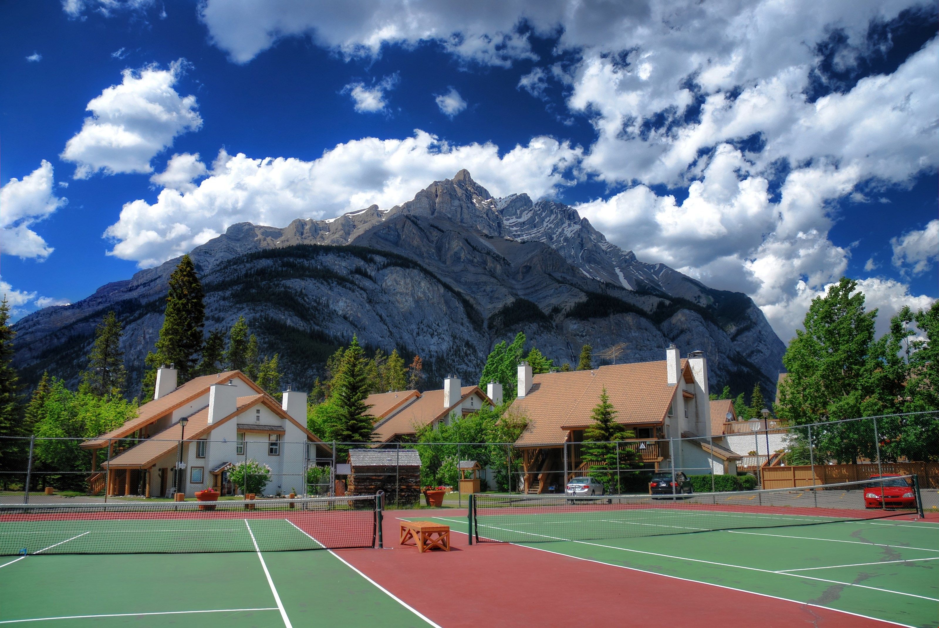 image Play a game of tennis in one of the most spectacular courts with views of the mountains!