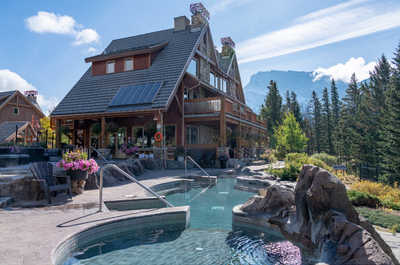 Relax in the crystal-clear hot pools at Hidden Ridge Resort in Banff, surrounded by majestic nature.