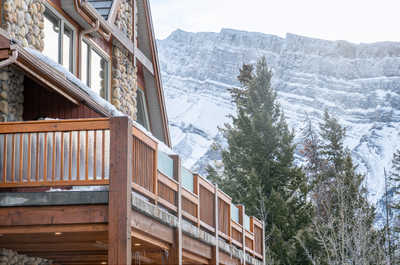Bask in the serene beauty of snow-covered mountain views from your cozy balcony at Hidden Ridge Resort.