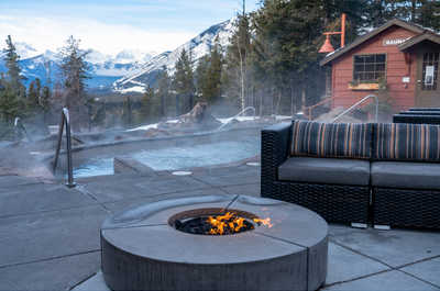 Revel in a snowy landscape while soaking in the warmth of an outdoor firepit.