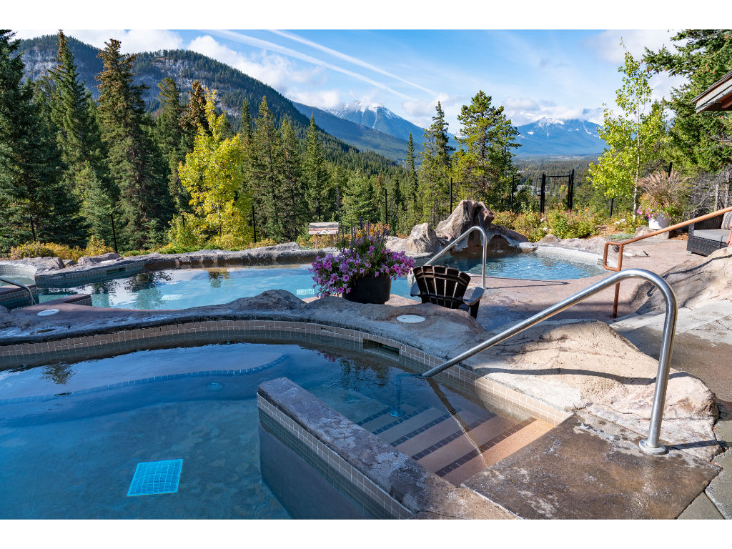 image Unwind in the serene shared hot pools with breathtaking vistas.