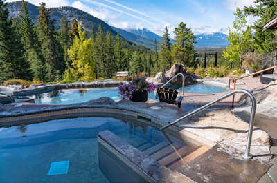Unwind in the serene shared hot pools with breathtaking vistas.