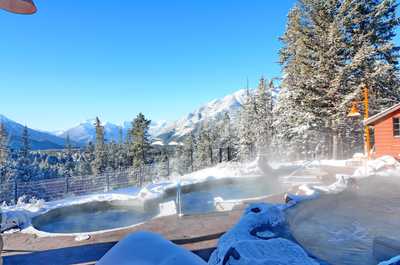 Revel in a snowy landscape while soaking in the SHARED hot tubs
