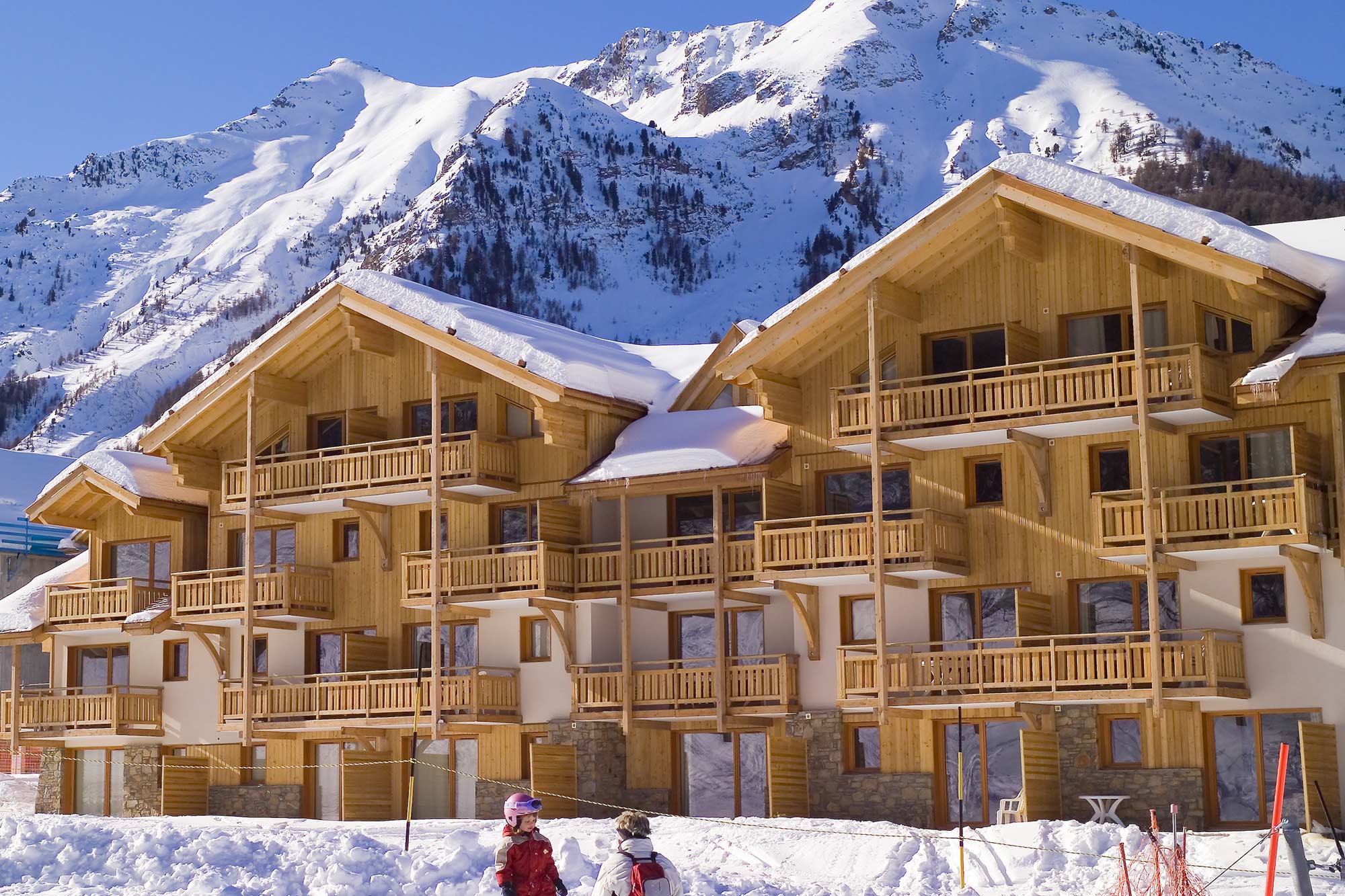 image Buildings in a snowy landscape with mountains in the background
