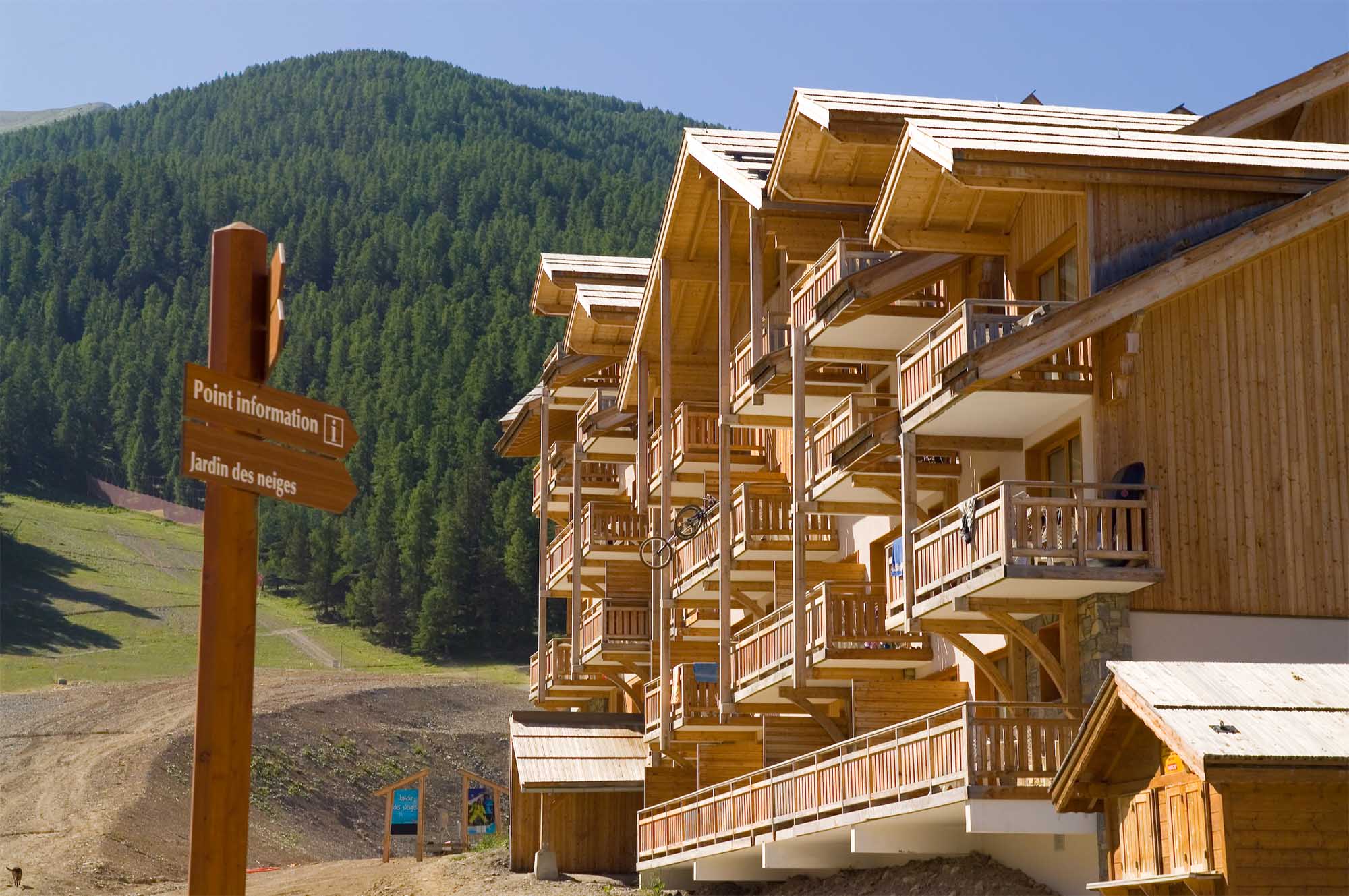 image Wooden buildings surrounded by greenery in summer