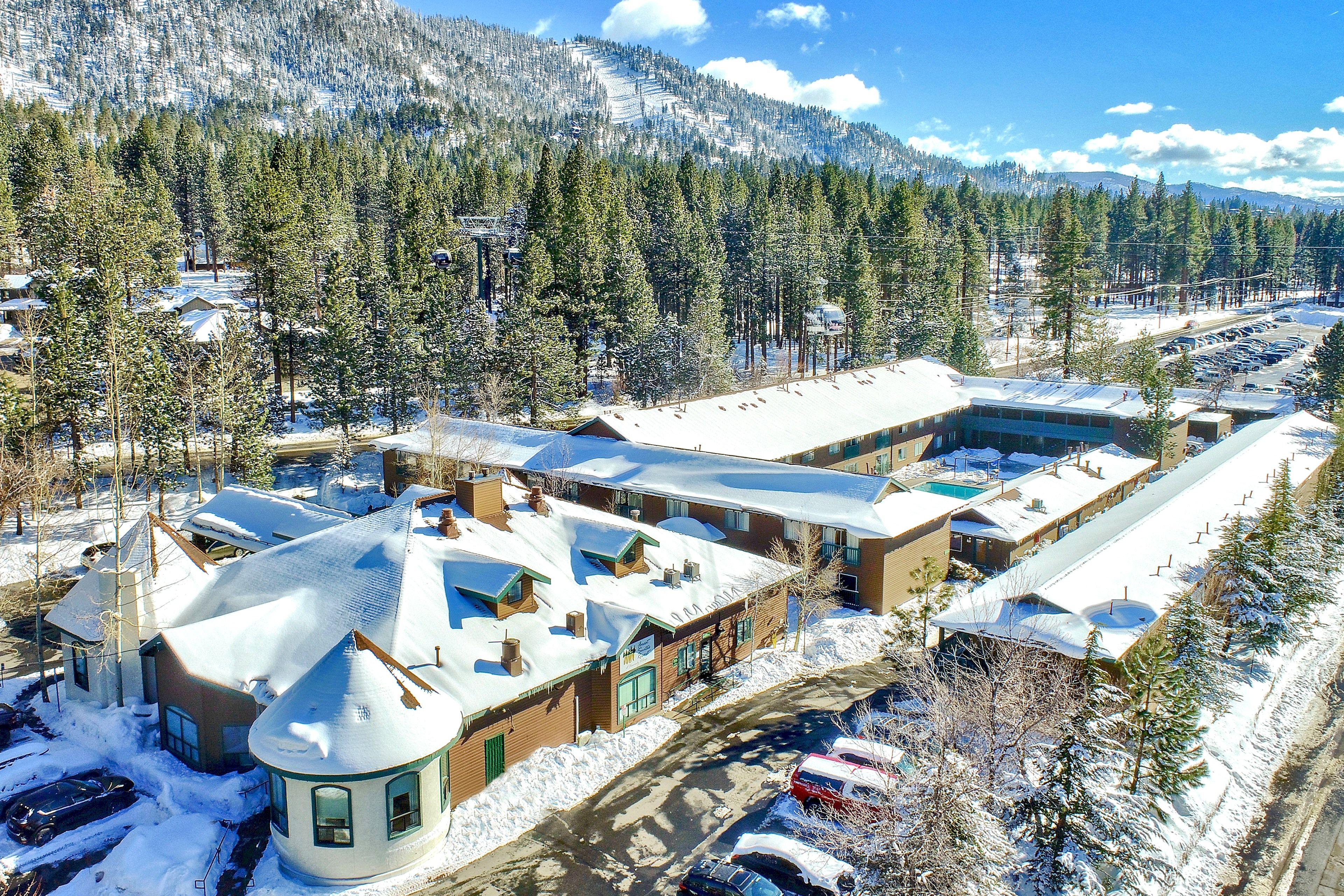 image Nestled among towering pines, this charming retreat offers a serene escape with stunning mountain views and a cozy alpine ambiance.