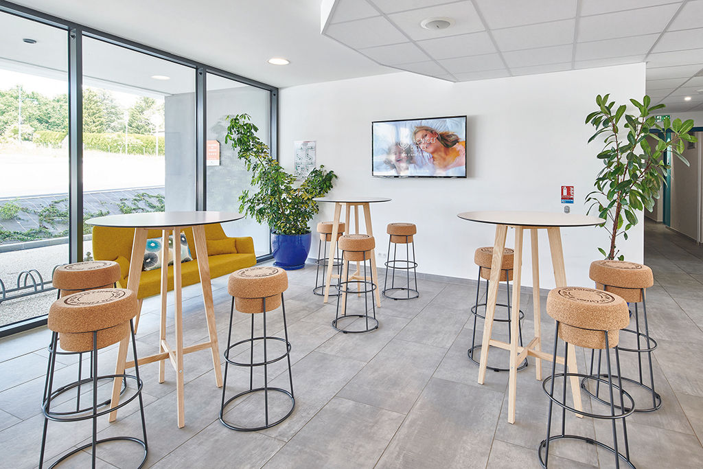 image Settle at the high tables and bar stools in the lounge, where large windows let in plenty of natural light