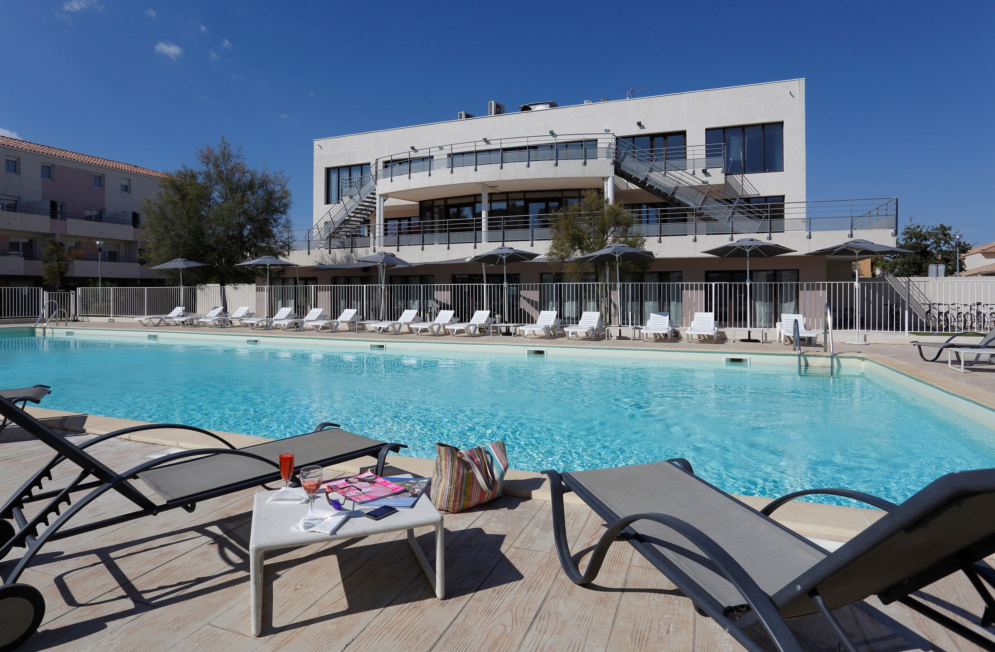 image Lounge by the pool in the sunshine.