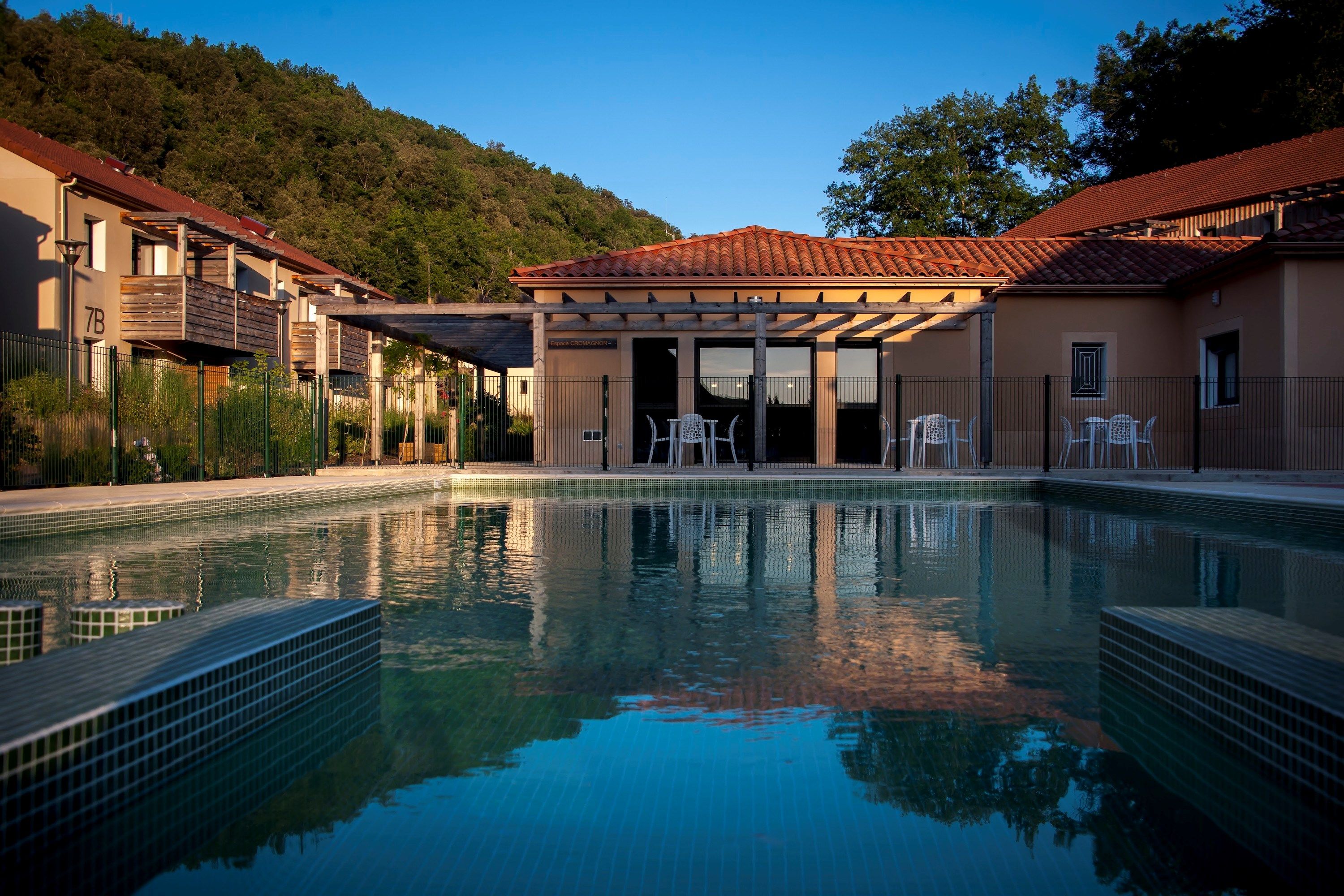 image Dive into tranquility with a refreshing swim surrounded by lush scenery and contemporary design.