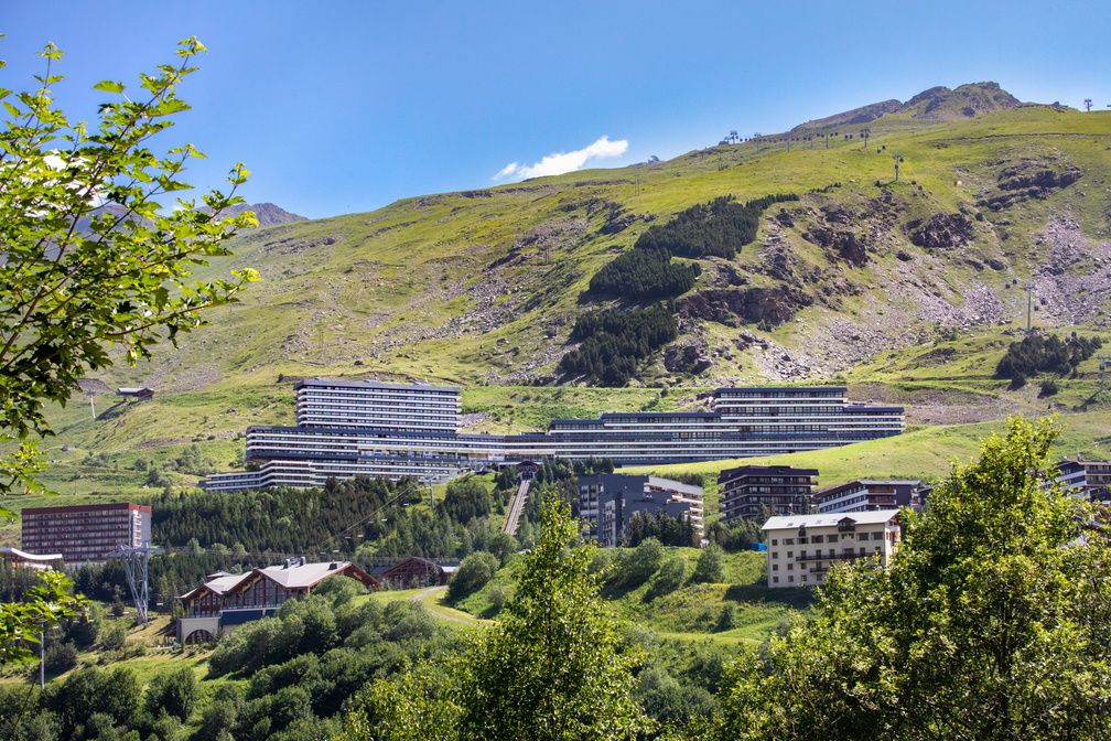 image Stepped terraces rising into the green hillside — the residence sits right in the heart of Les Menuires.