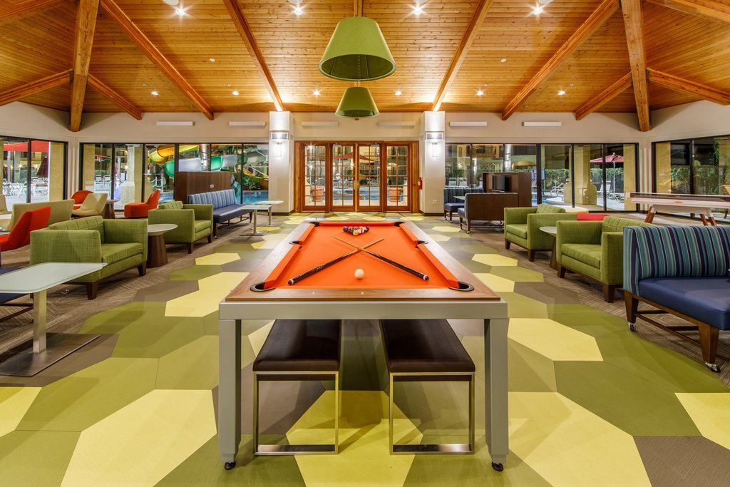 image Challenge friends to a game of pool in a lively space where laughter and good times abound.