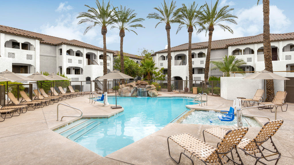 image Plunge into relaxation by the pool, surrounded by swaying palms and inviting lounge chairs.