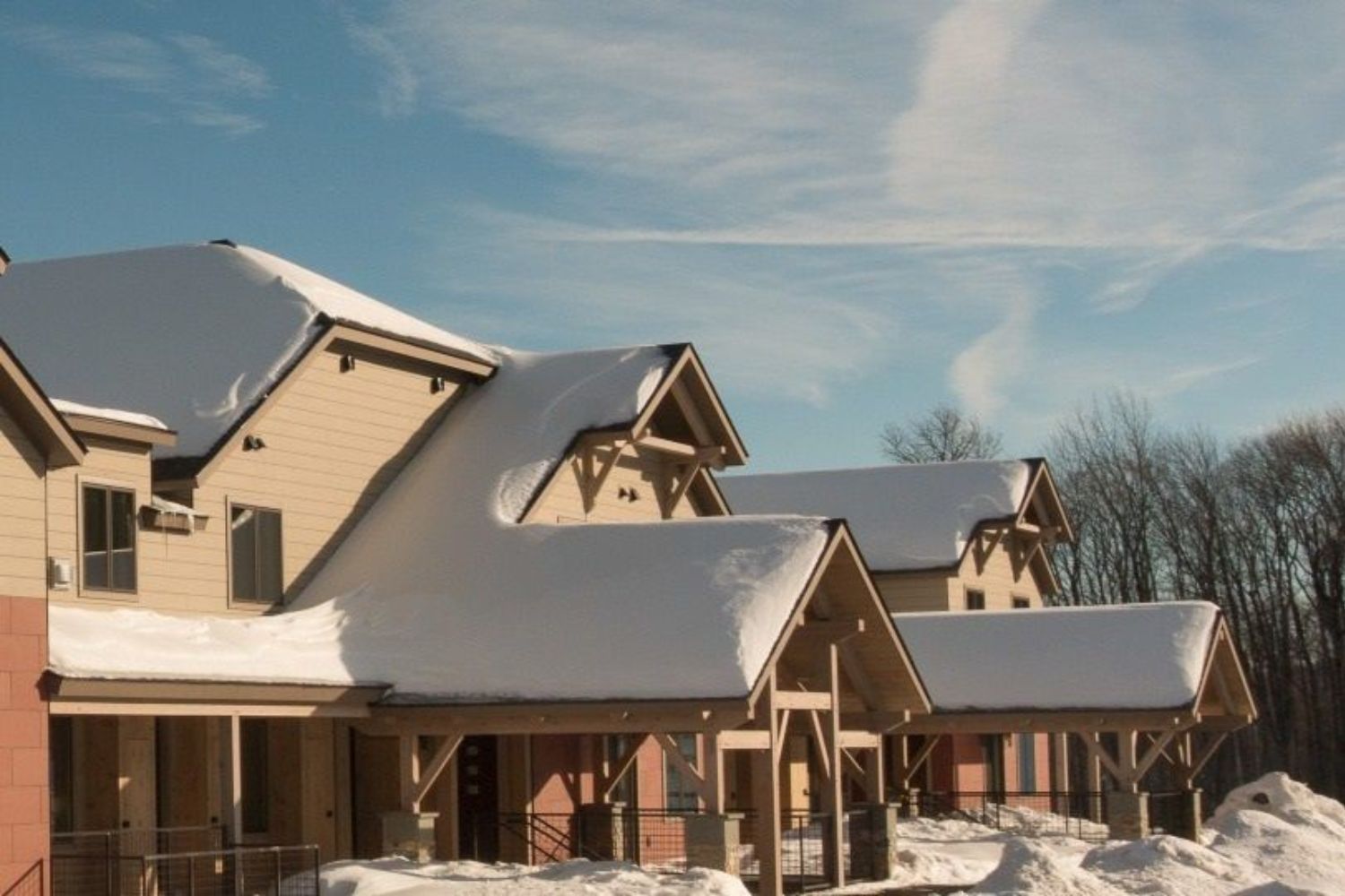 image Nestled under a soft blanket of snow, the charming architecture of South Face Village Condominiums beckons guests to experience the serenity of winter in the heart of Vermont's picturesque Okemo Mountain.