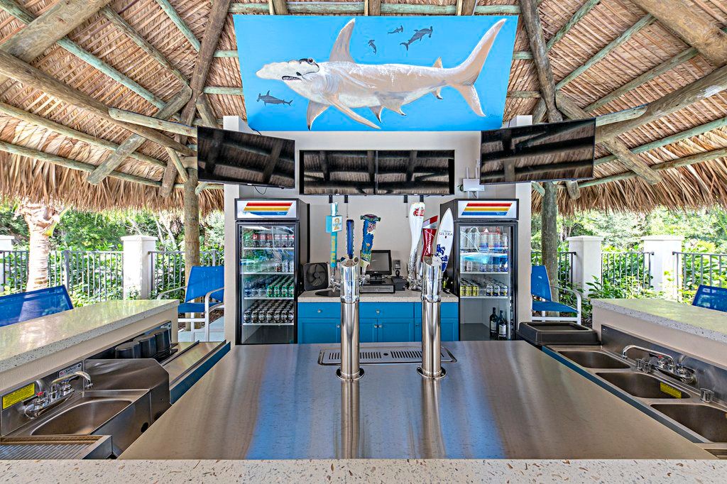 image Enjoy refreshing drinks at the vibrant tiki bar, perfectly designed for relaxation under the sun.