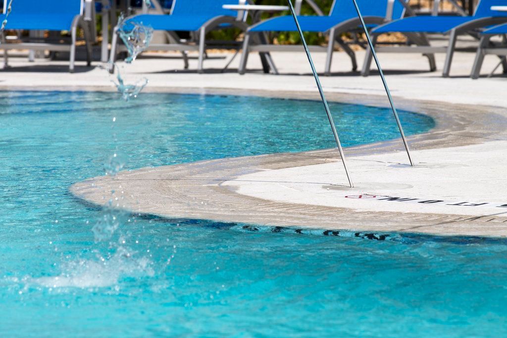 image Splash into relaxation with a refreshing dip in the pool, surrounded by comfy loungers.