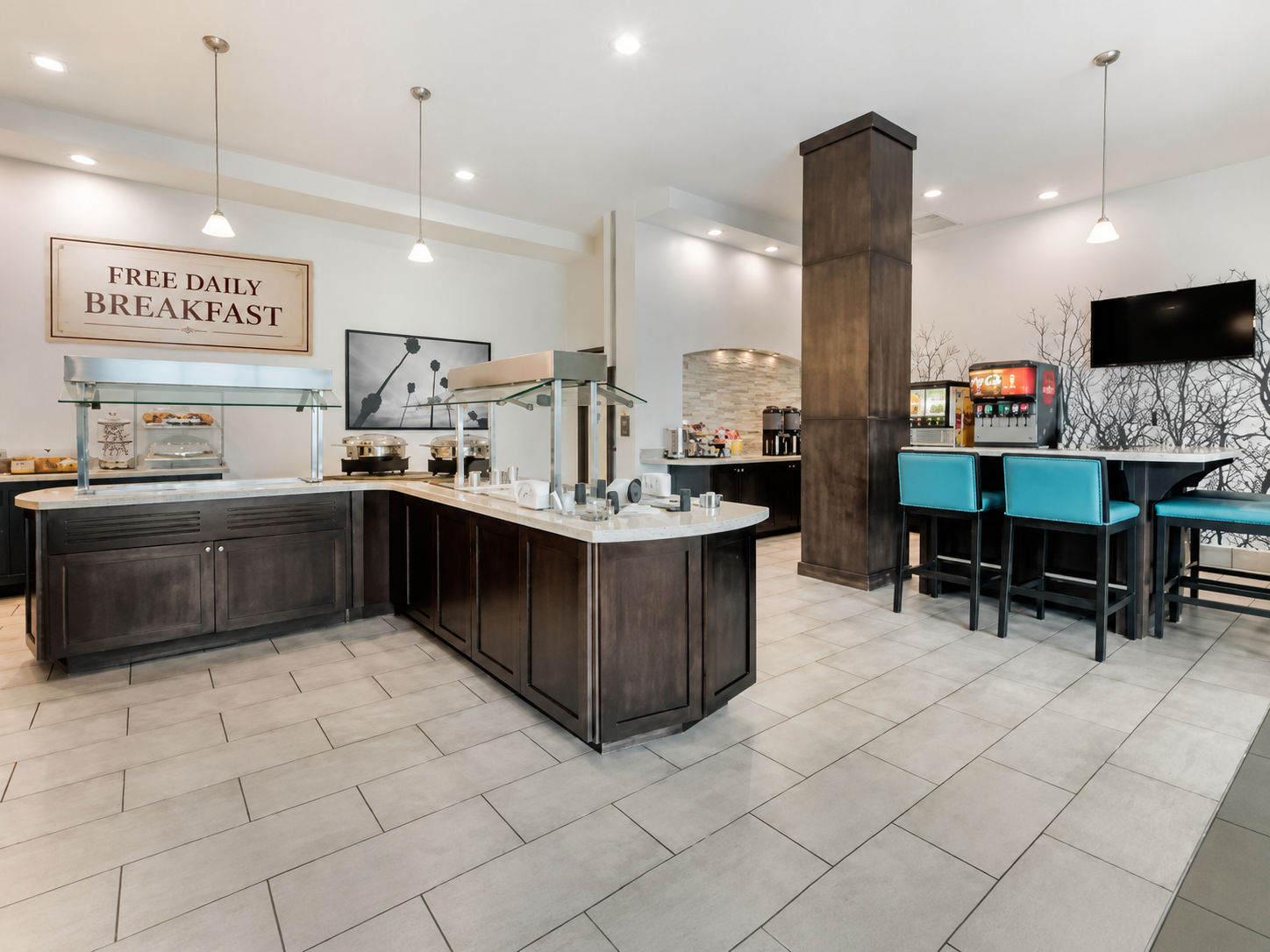 image Breakfast and social area with buffet counter, pendant lights, and turquoise bar seating