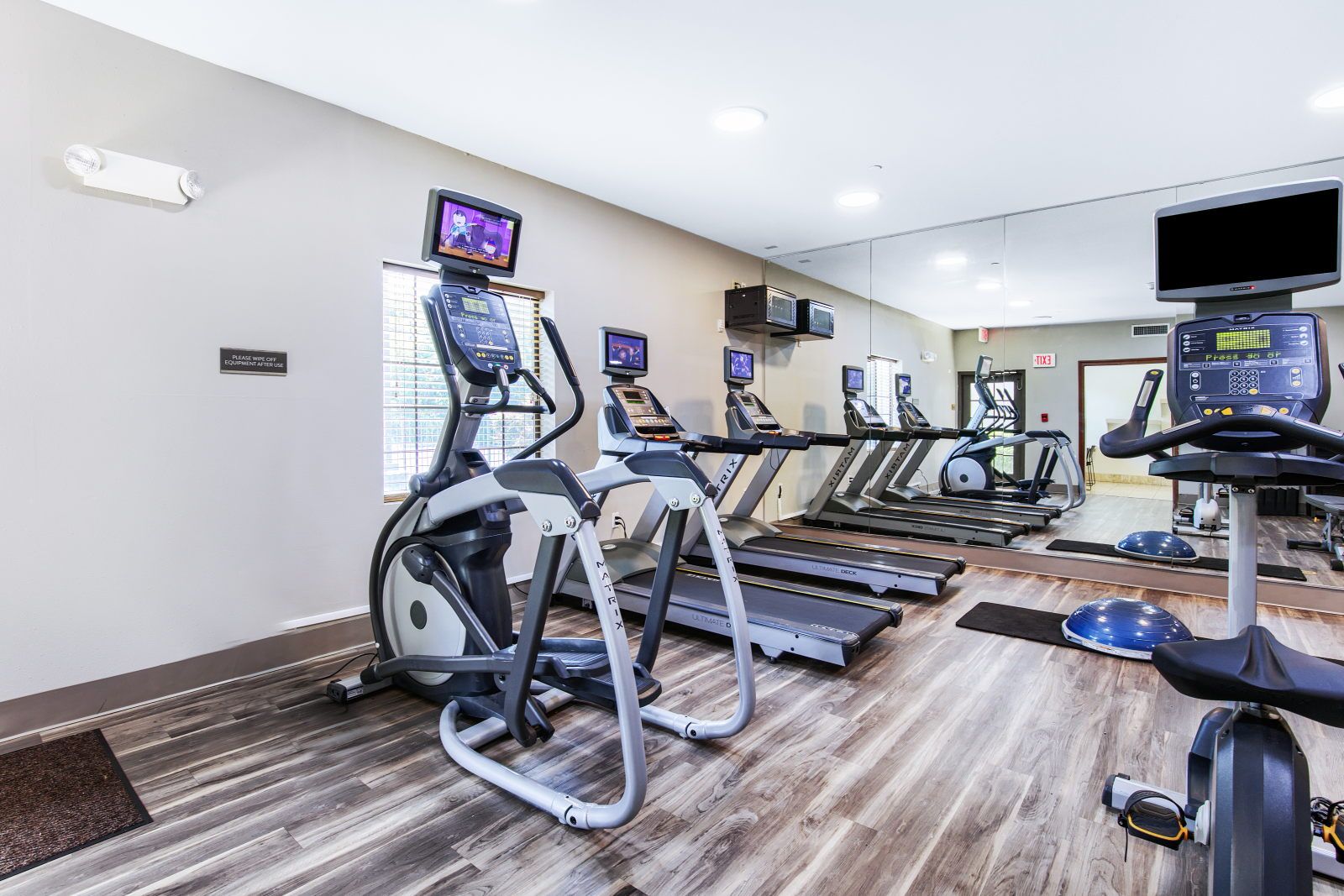 image Fitness center with elliptical trainer, treadmills, and stationary bike
