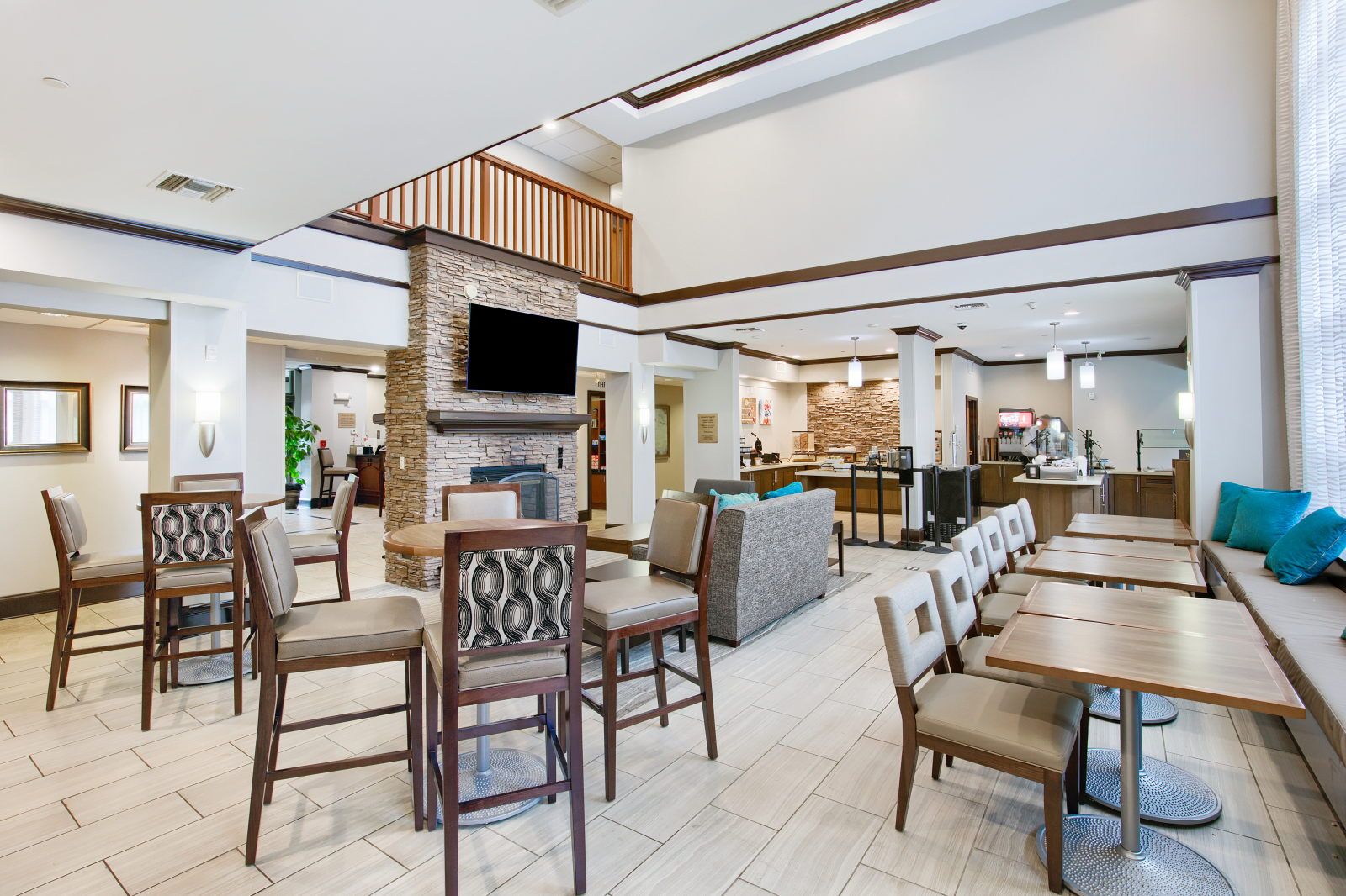 image Open lobby and dining area with stone fireplace and breakfast counter