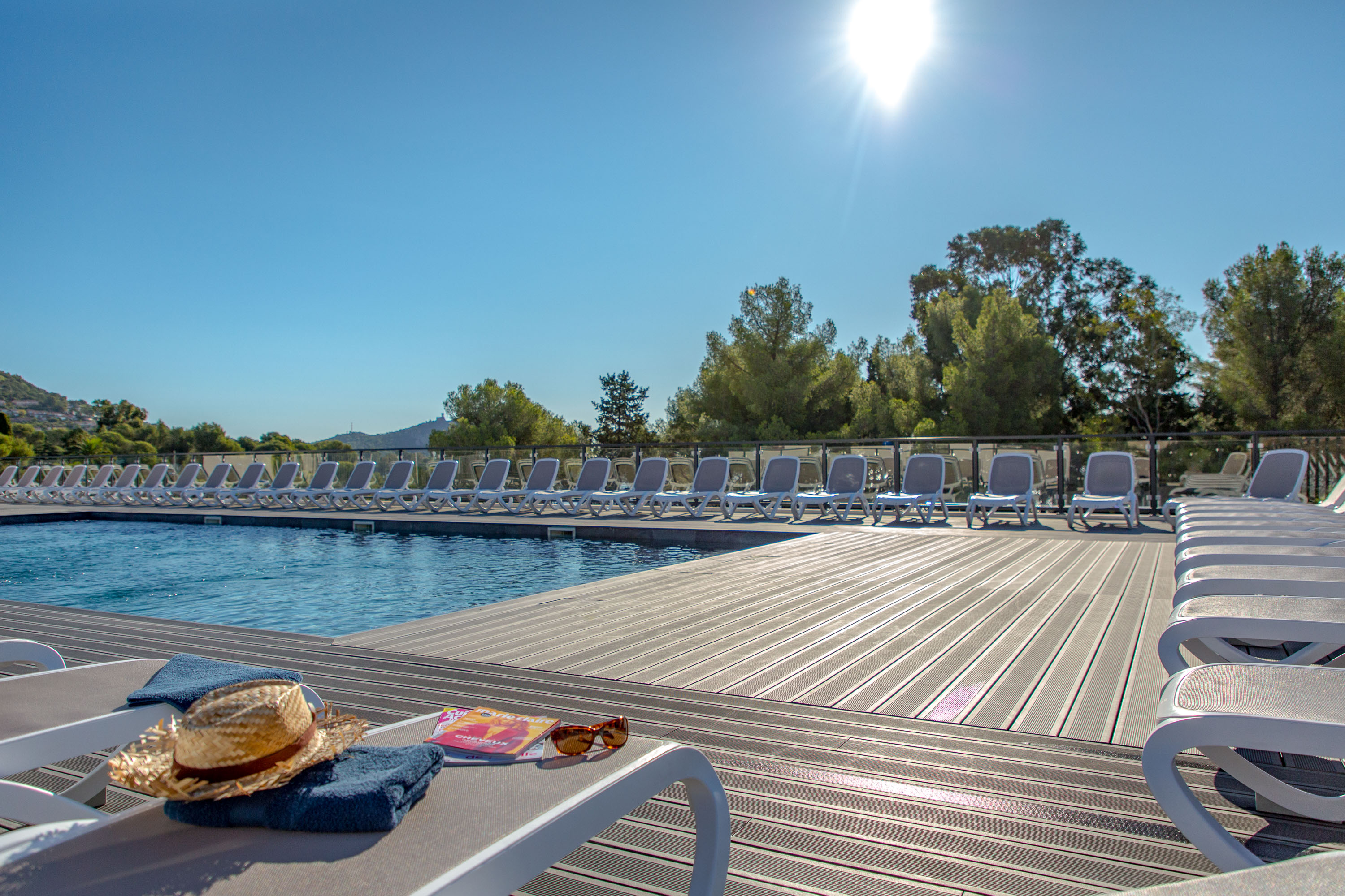 image Lounge in the sun by the outdoor pool.