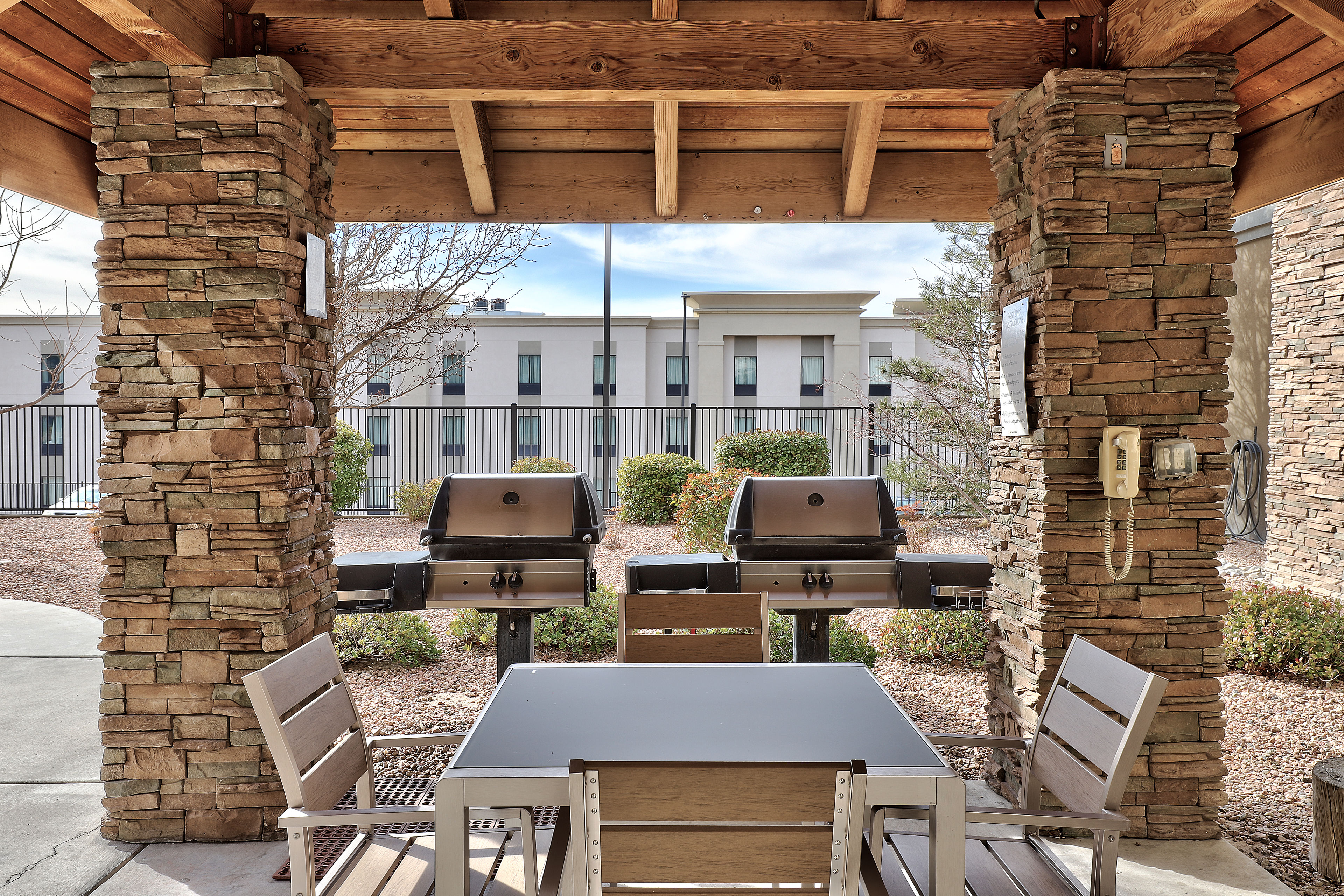 image Covered outdoor grill and dining area with tables