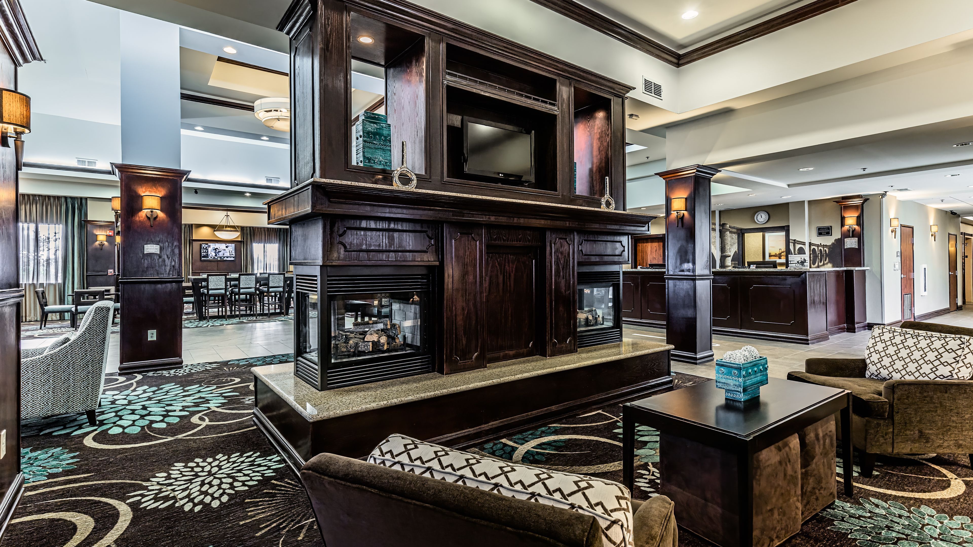image Settle into the lobby lounge with warm wood accents and deep leather seating