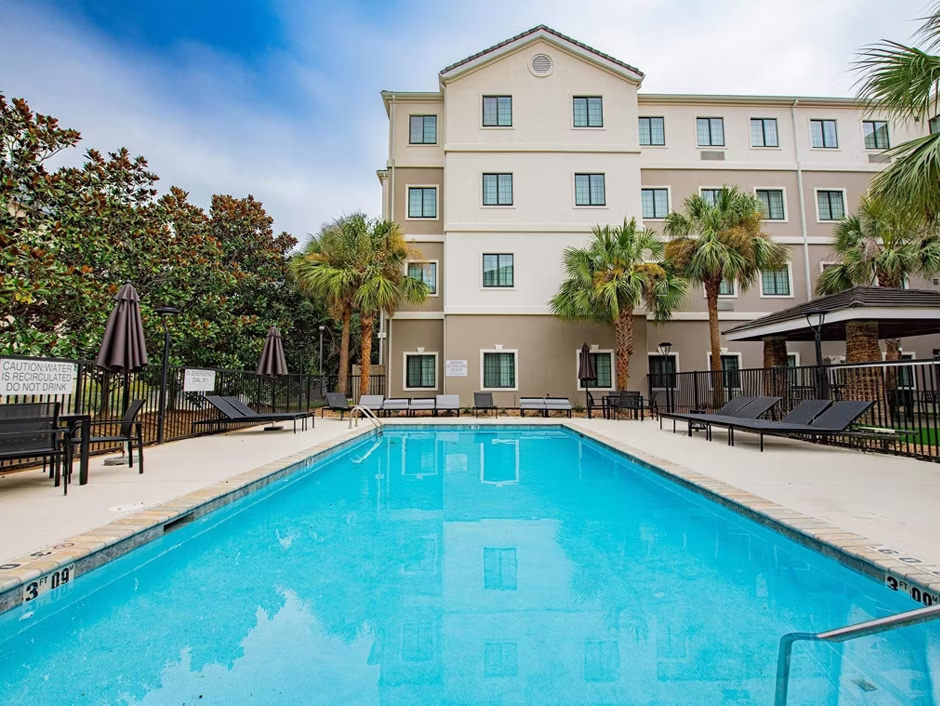 image Take a dip in the refreshing pool, surrounded by comfortable lounge chairs and lush greenery.