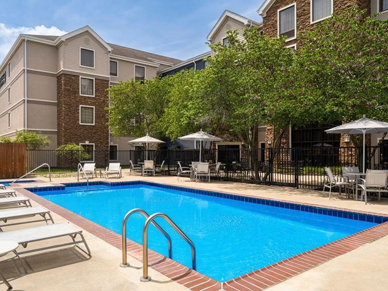 image Inviting swimming pool with lounge chairs.