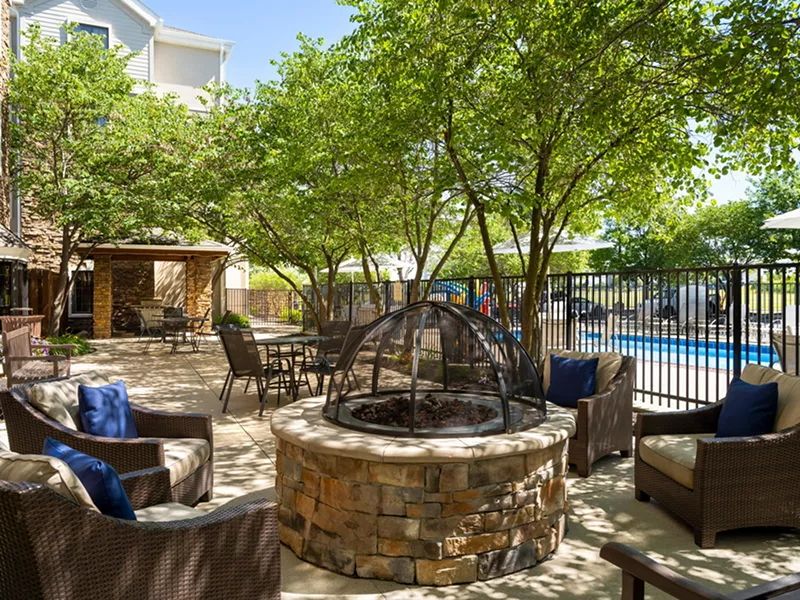 image Cozy outdoor sitting area with fire pit.