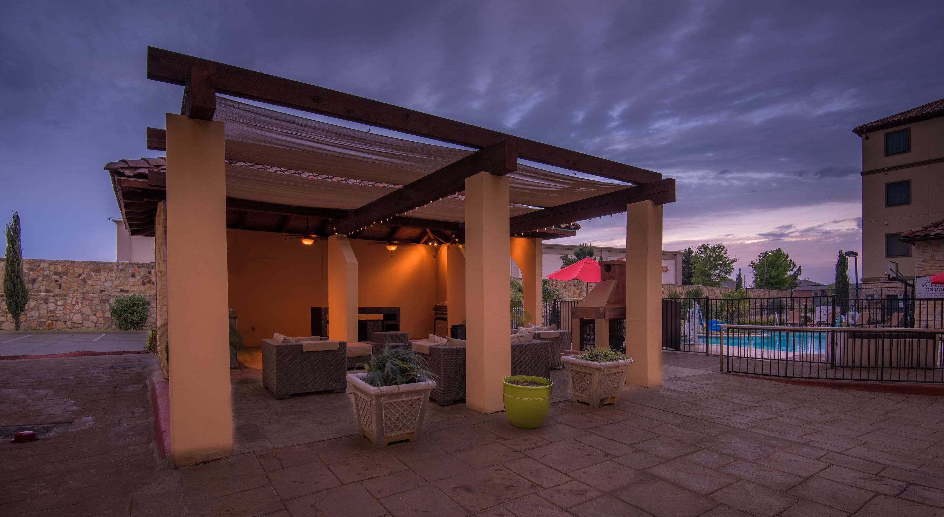 image Outdoor seating area with pool view.