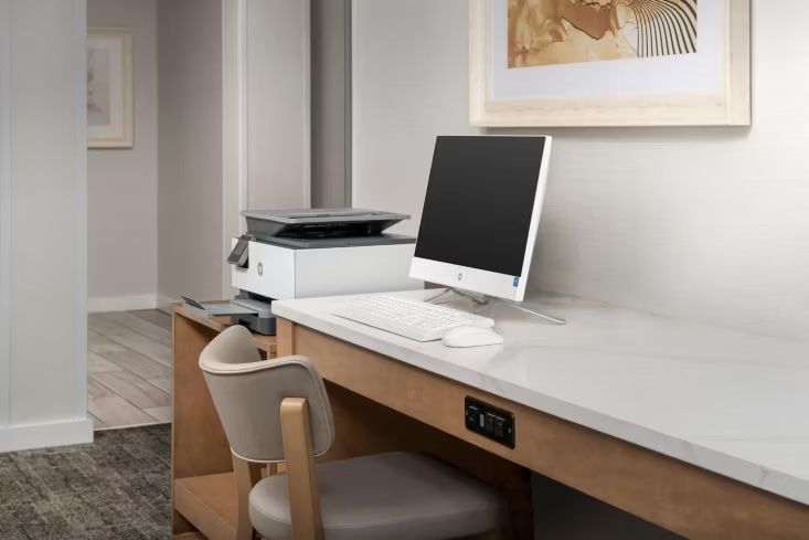 image Work desk with HP printer, desktop computer, and keyboard — available in the 24-hour business center