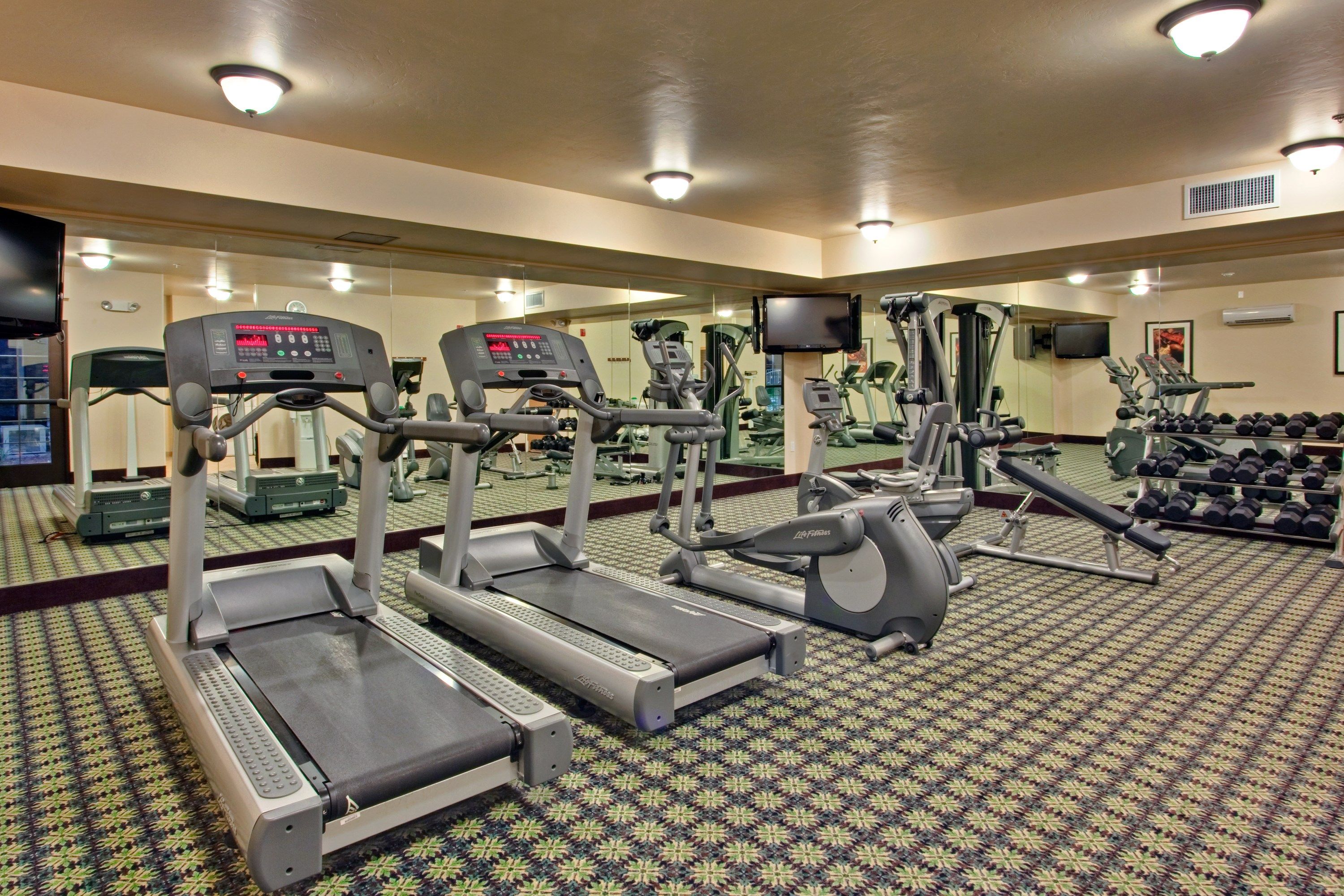 image Fitness center with treadmills and weight training machines.