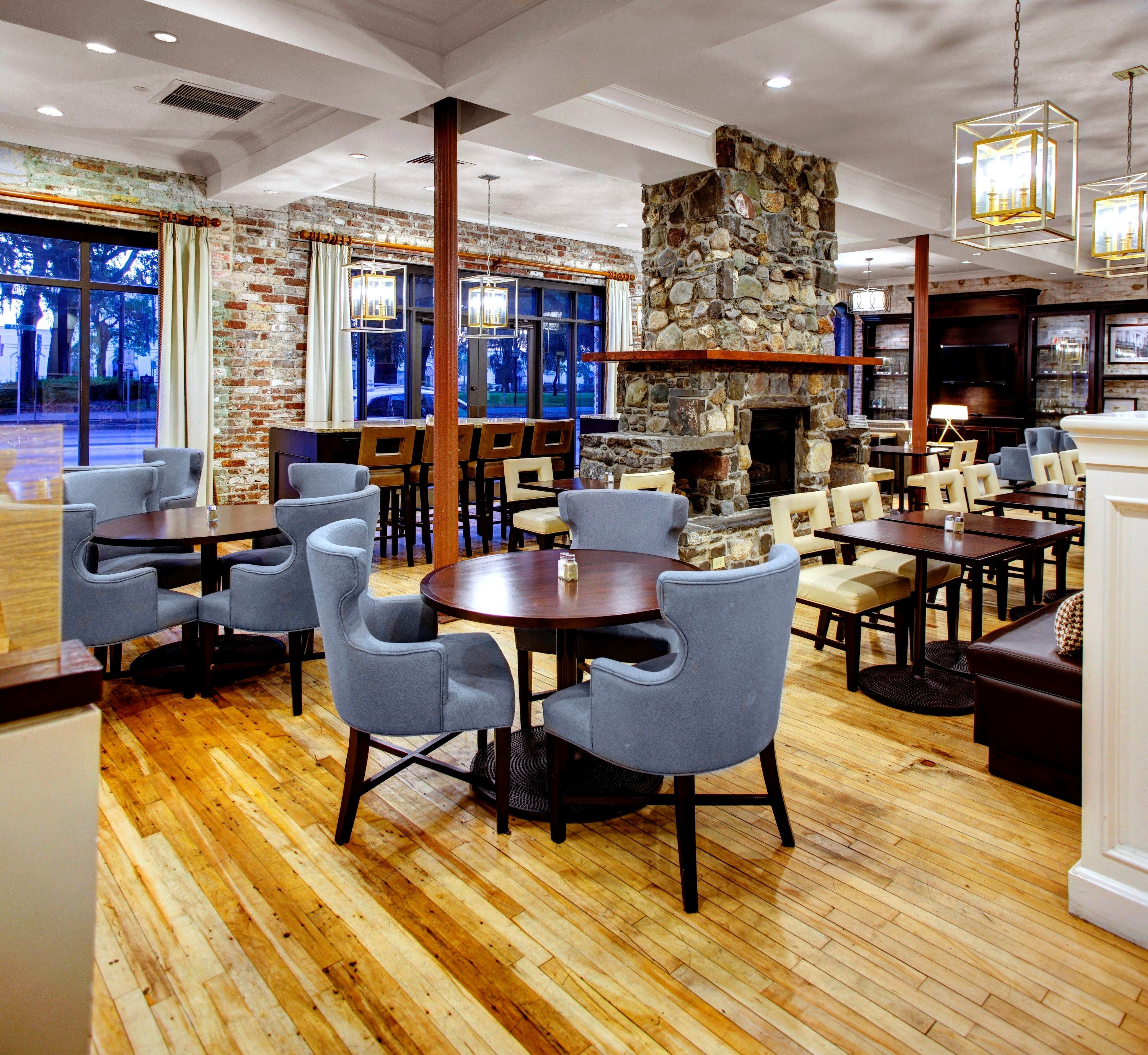 image Bright breakfast and dining lounge with tables, chairs, and a warm, inviting atmosphere.