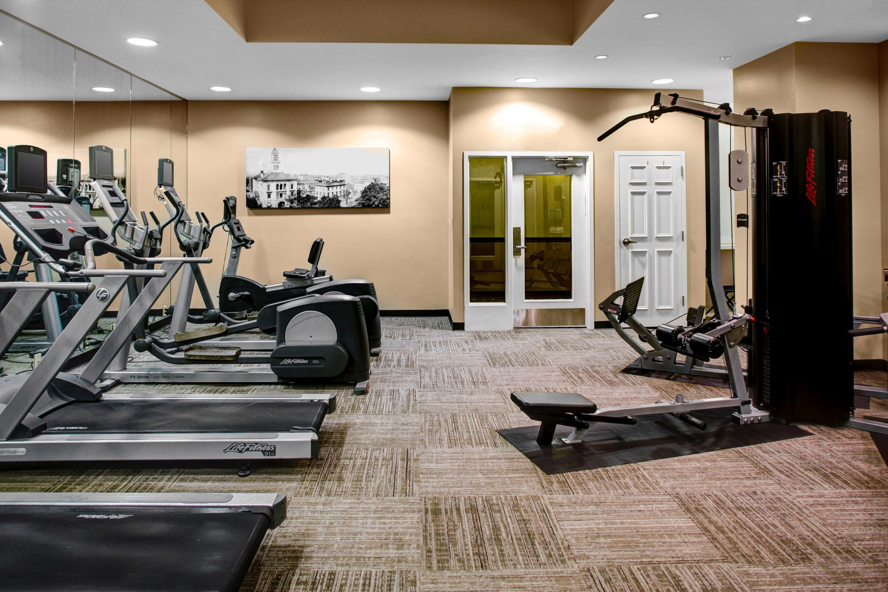 image Well-equipped fitness center with cardio machines and strength training equipment.
