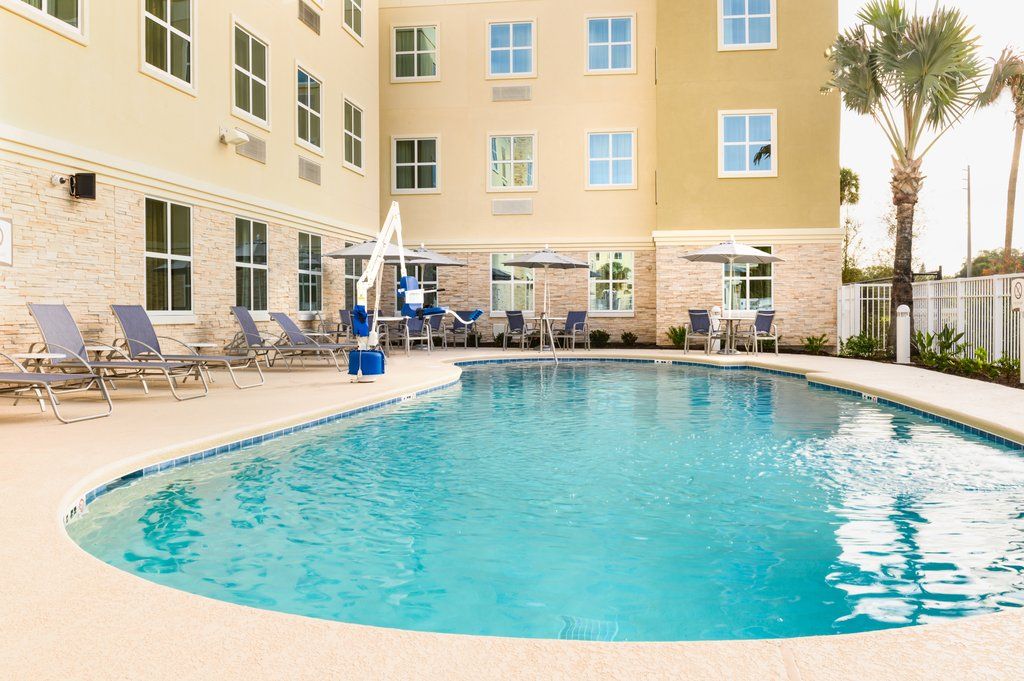 image The sparkling outdoor pool, surrounded by lounging chairs, invites guests to enjoy refreshing relaxation under the sun.