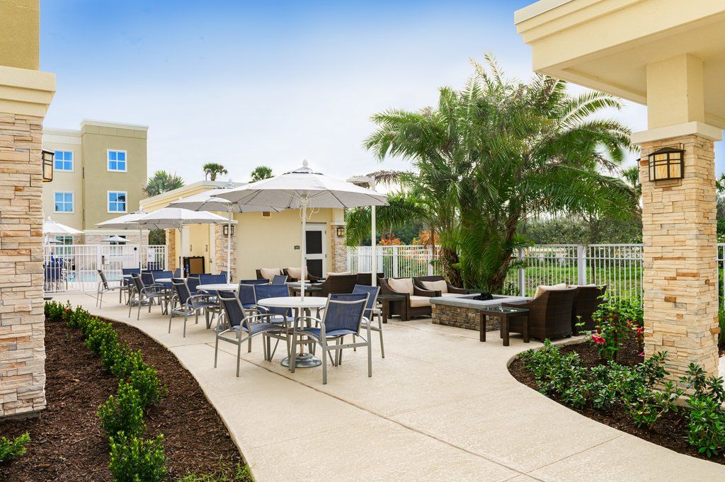 image The outdoor patio features comfortable seating, shaded umbrellas, and vibrant landscaping, perfect for relaxation and socializing.