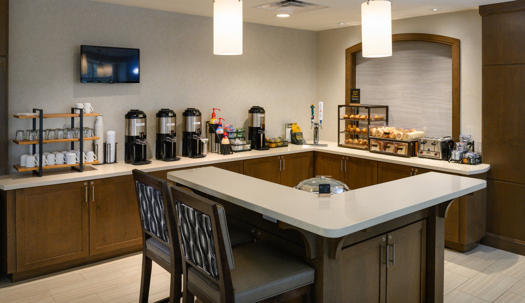 image The breakfast bar showcases a variety of coffee options and pastries, creating a welcoming start to the day for guests.