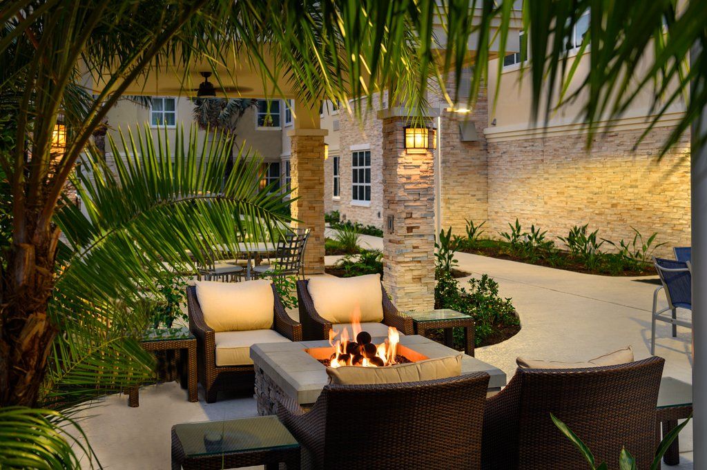 image The cozy outdoor fire pit area, surrounded by lush greenery, provides a warm and intimate spot for evening gatherings.