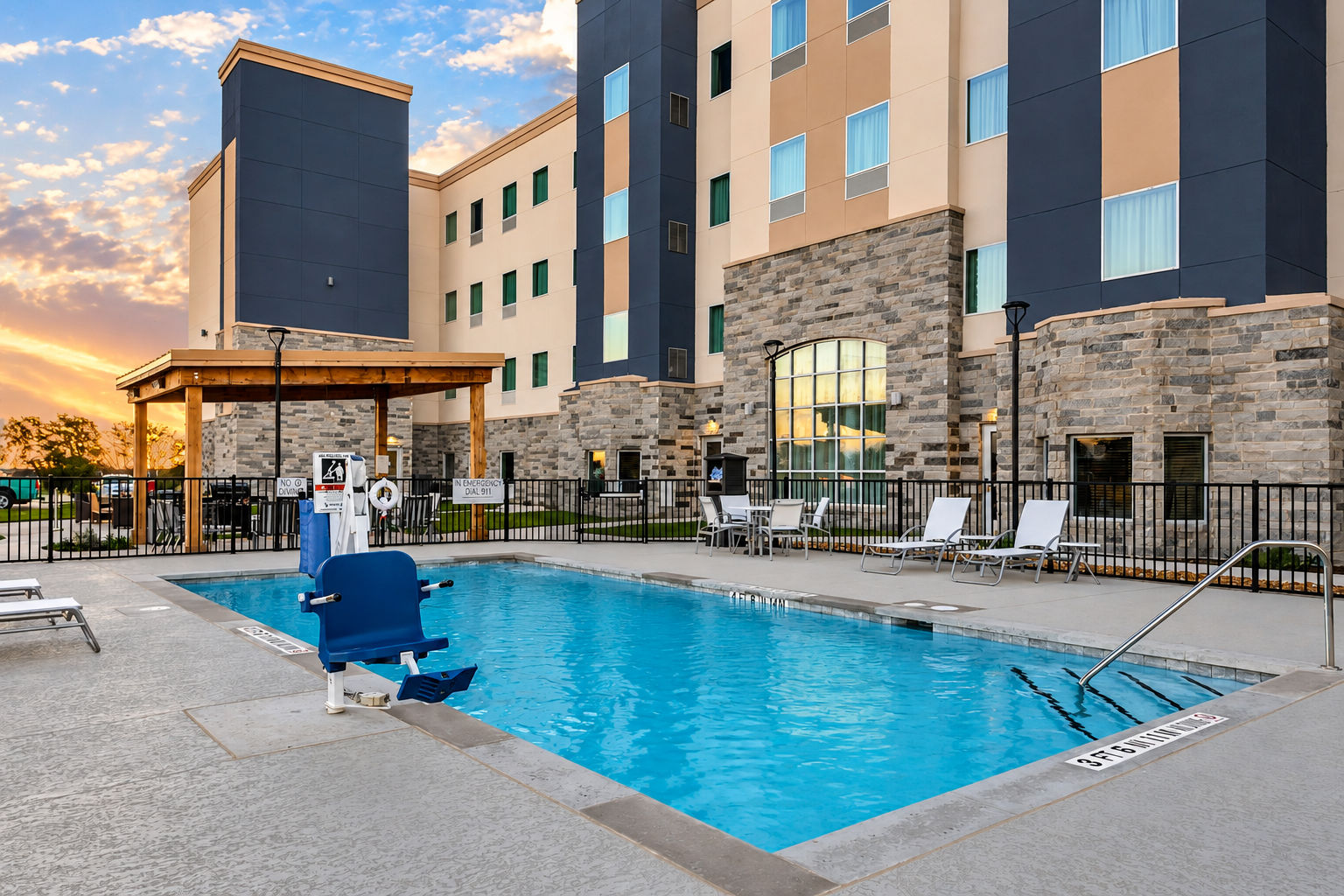 image Dive into relaxation at the inviting outdoor pool, perfect for unwinding under the sun.