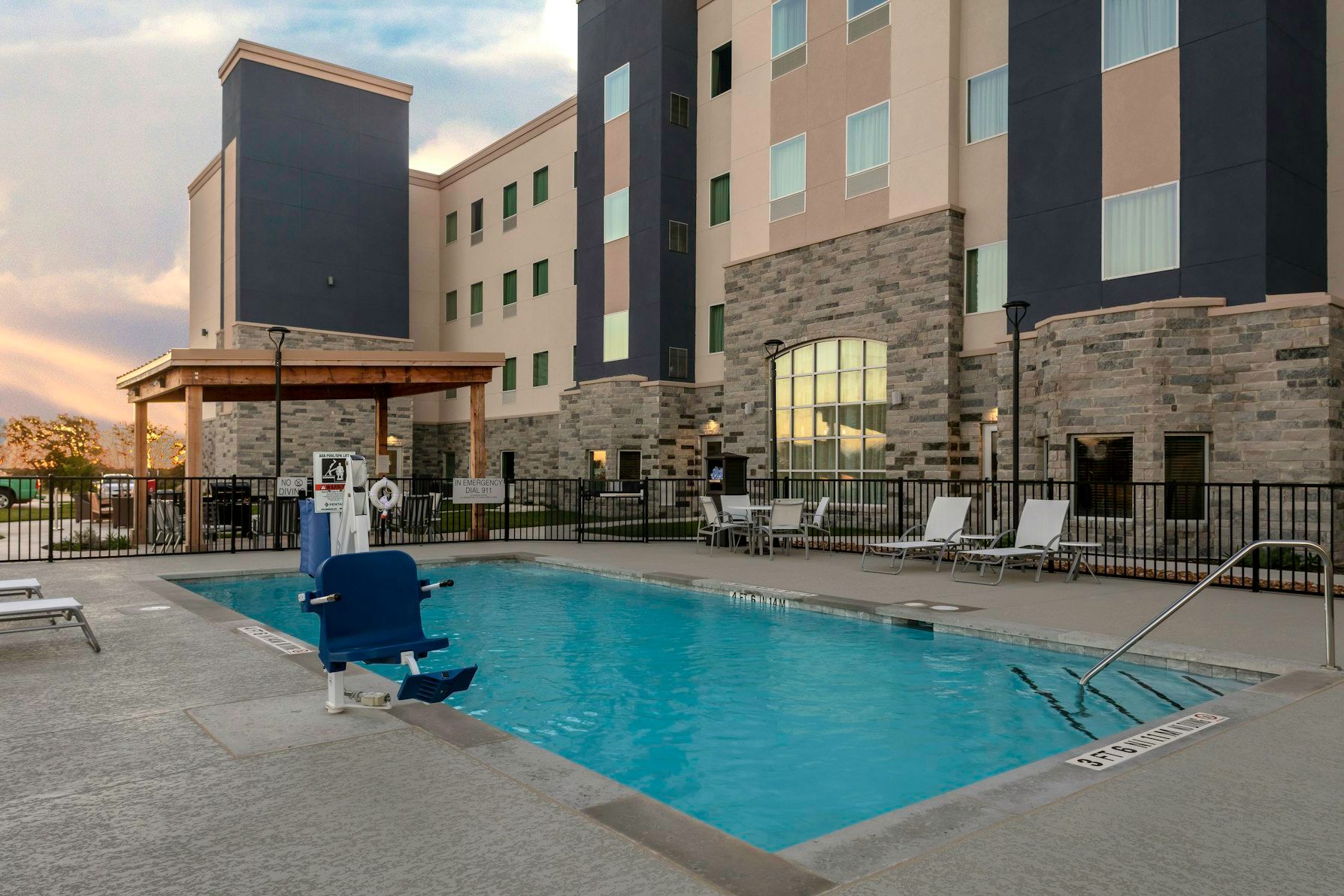 image Dive into relaxation at the inviting outdoor pool, perfect for unwinding under the sun.