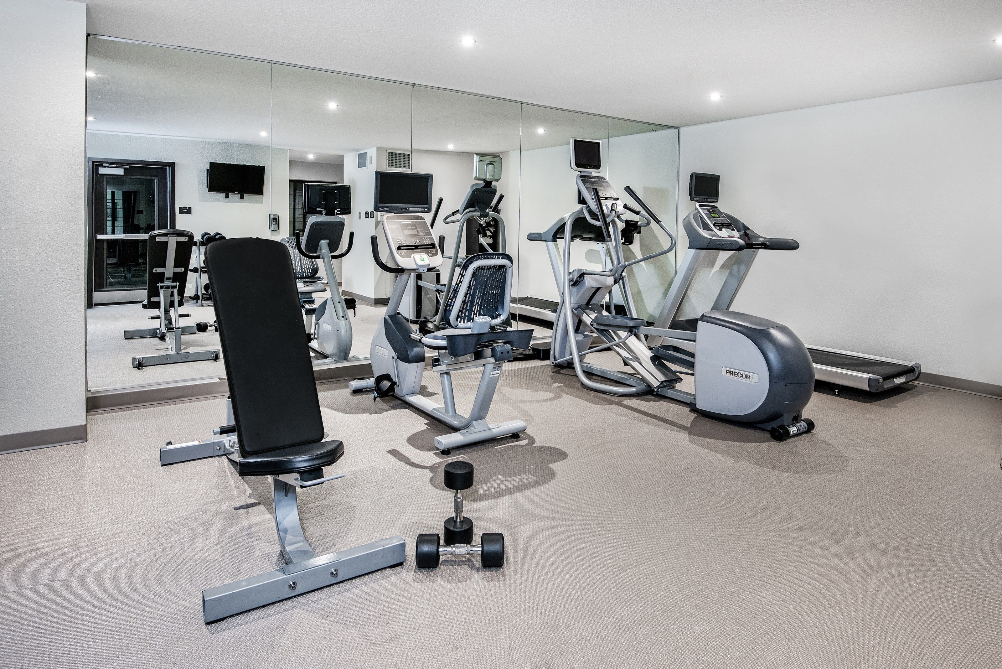 image The gym features modern workout equipment, including treadmills and stationary bikes, for guests looking to stay active.