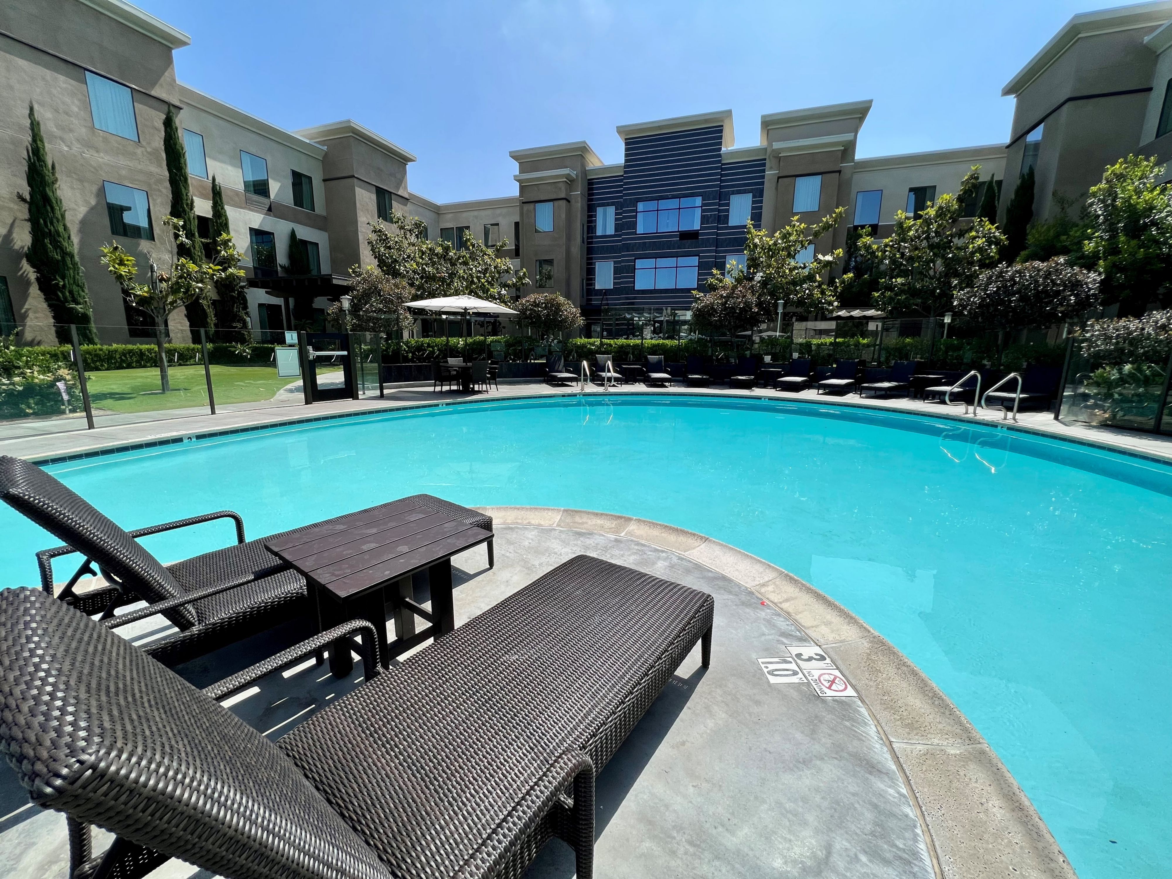 image Refreshing swimming pool with sun loungers and a serene atmosphere.