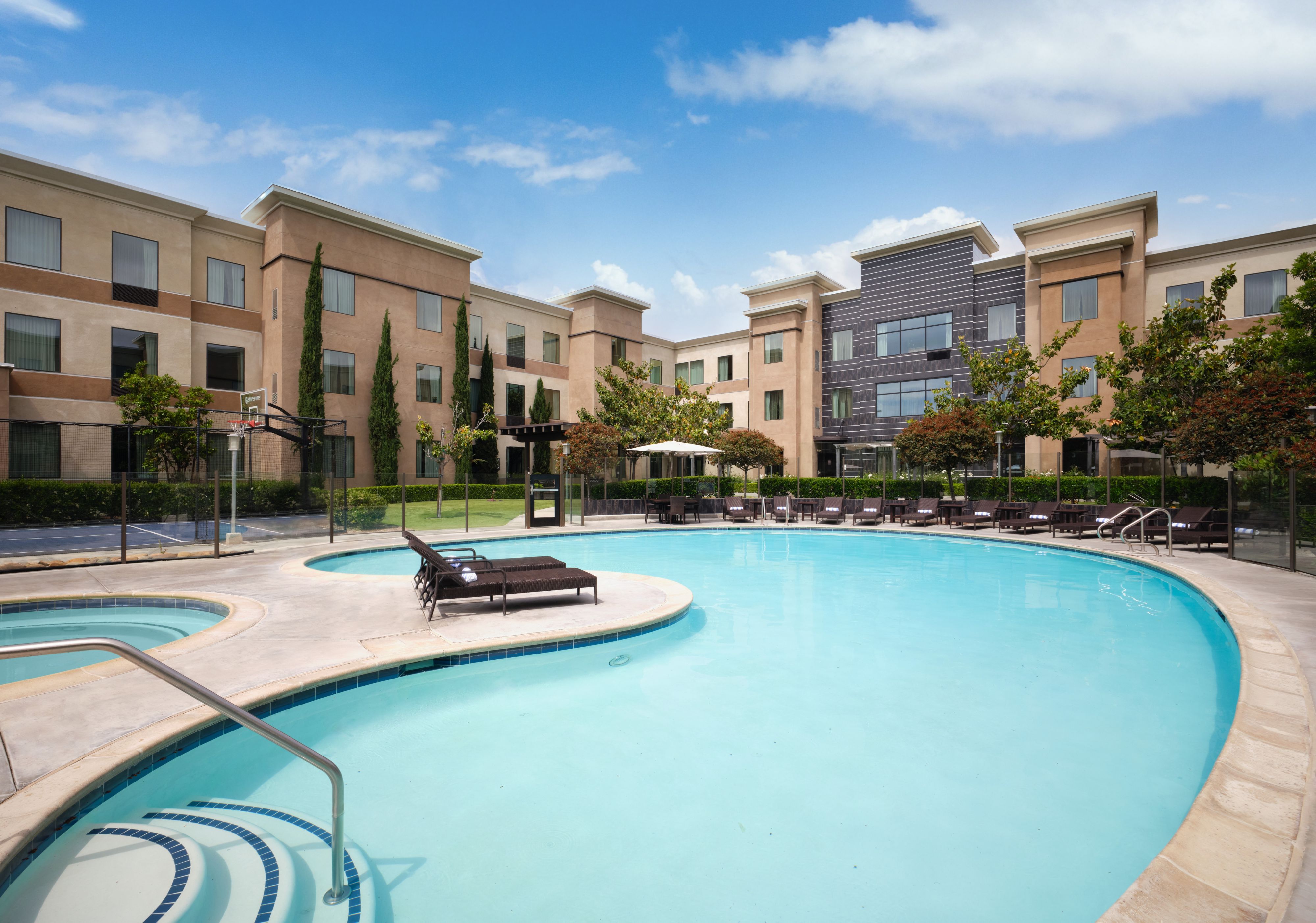 image Elegant view of the poolside area with lounge chairs and well-maintained landscaping.