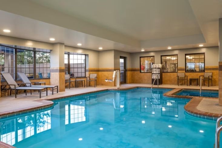 image Enjoy a refreshing swim in the indoor heated pool, surrounded by natural light and comfortable lounge chairs